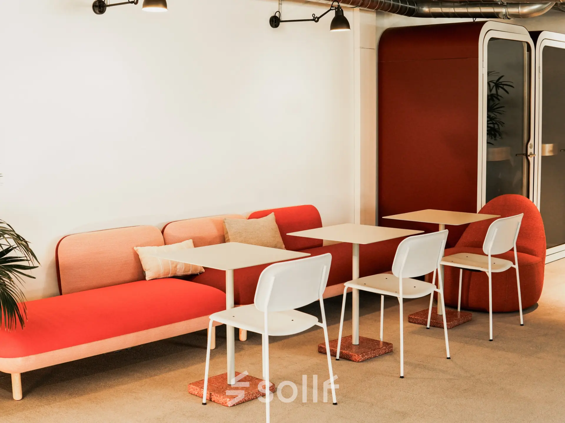 Moderner Büroraum mit farbenfrohen Sitzgelegenheiten und Tischgruppe, ideal für kreative Meetings. Perfekt für alle, die in Zürich City ein Büro mieten möchten.