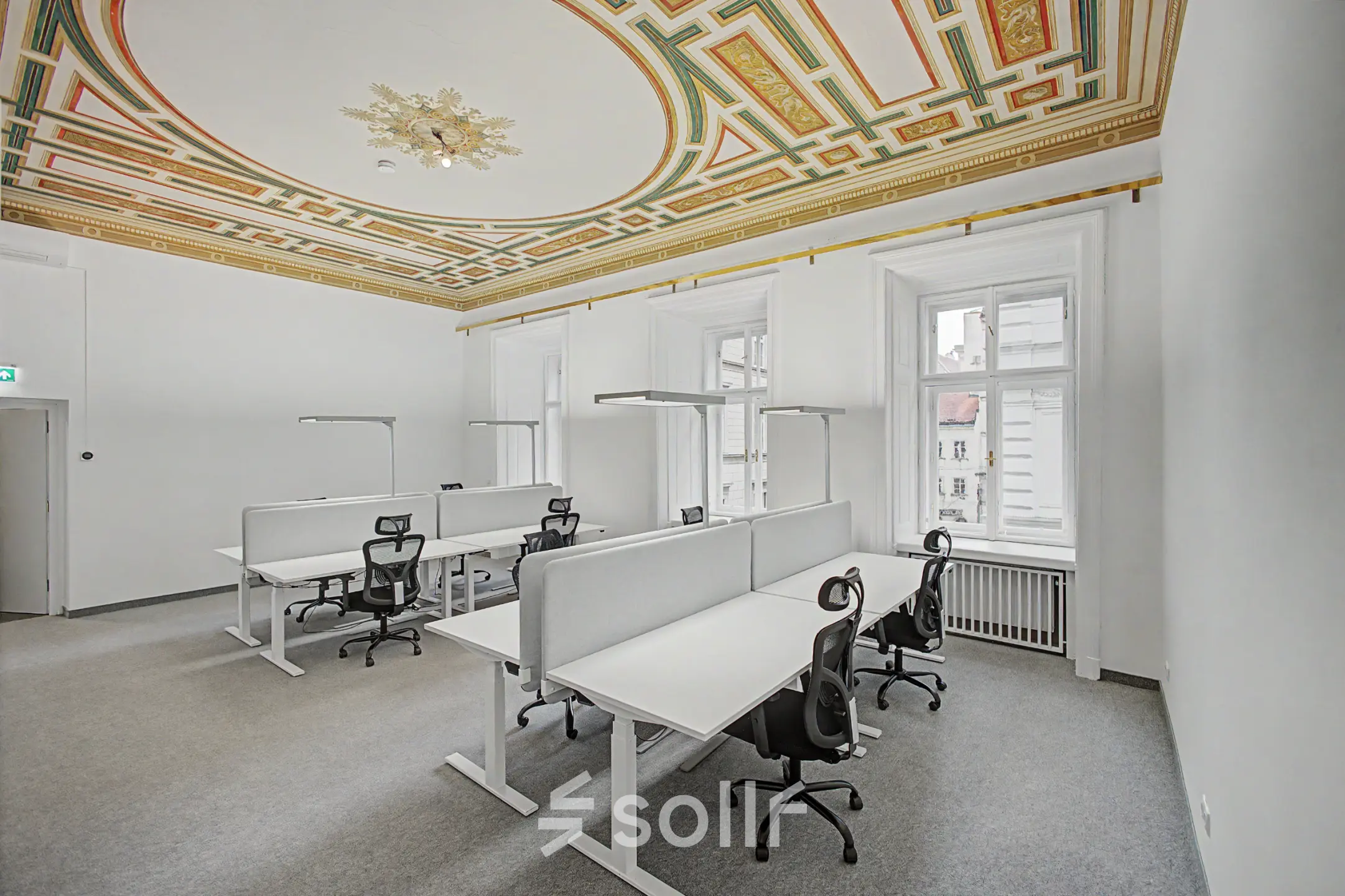 Bright, furnished office space with elegant ceiling design, featuring several workstations available for rent at Wollzeile 11, 1010 Vienna Center.