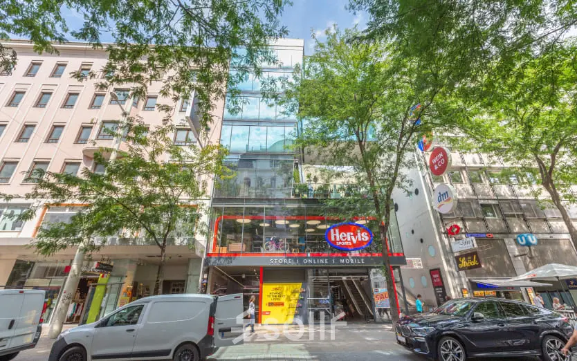 Street view of Mariahilfer straße 36 in 1070 Vienna, featuring a modern building with glass facade, ideal for office space rental.