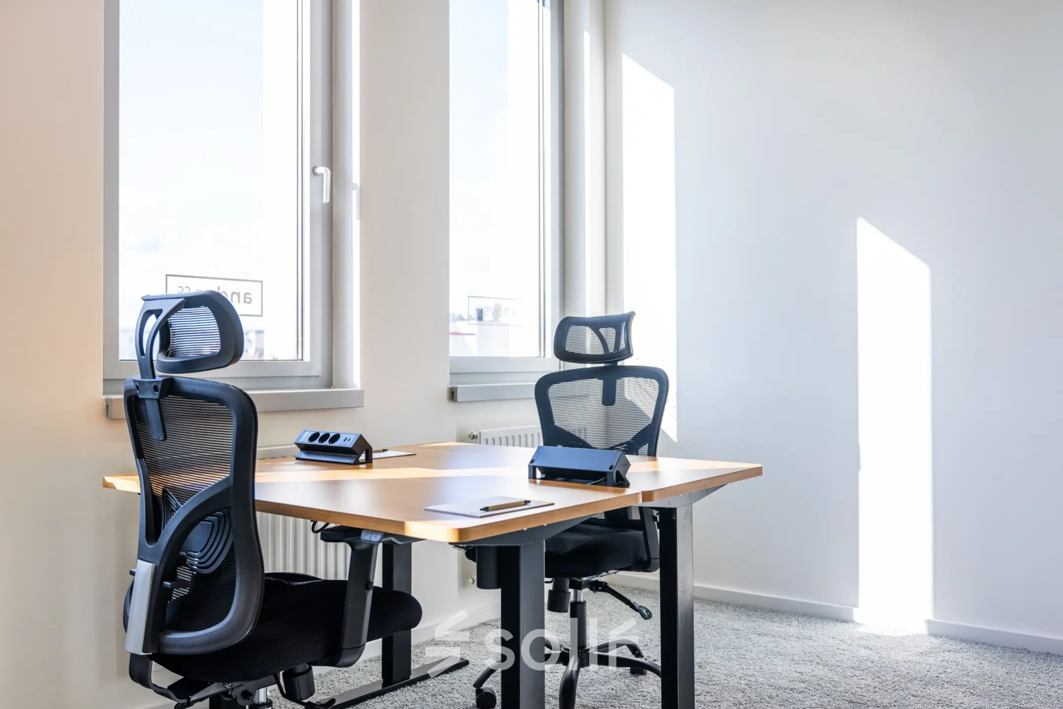 Bright office space with two ergonomic chairs and desks available for rent at Schönbrunner Strasse 230, 1120 Vienna, ideal for focused work.