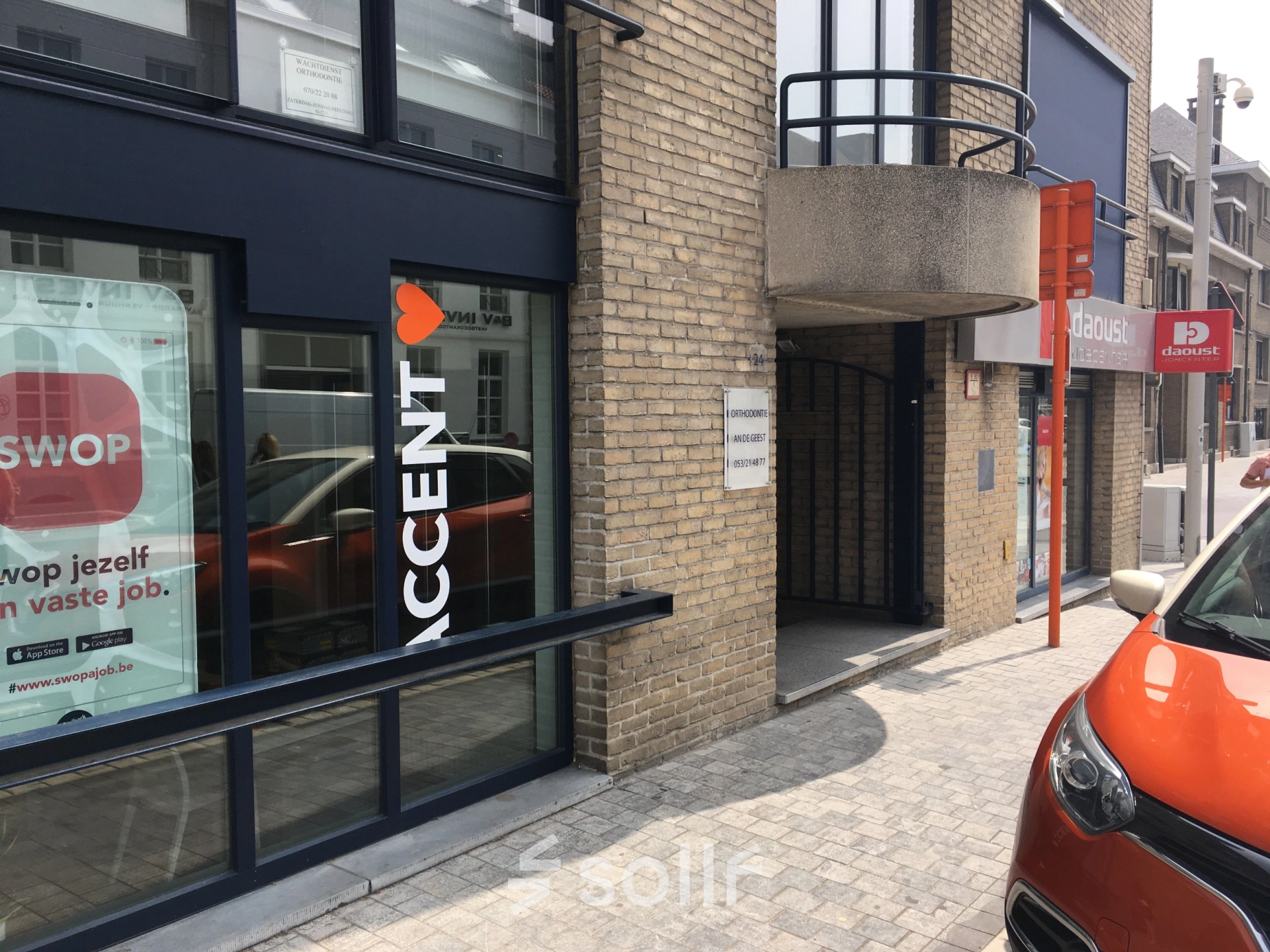 Exterior view of an office building located at Keizersplein 24, Aalst België, featuring signage and a street view.