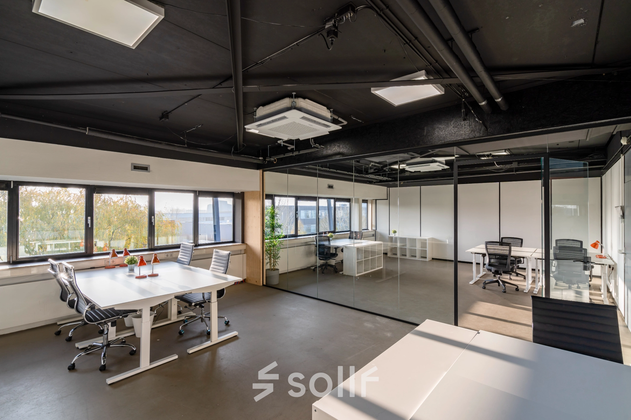 Modern office space for rent at Transistorstraat 151 in Almere Poort, featuring bright open workspaces with large windows, sleek glass partitions, and comfortable seating, perfect for collaborative work and productivity.