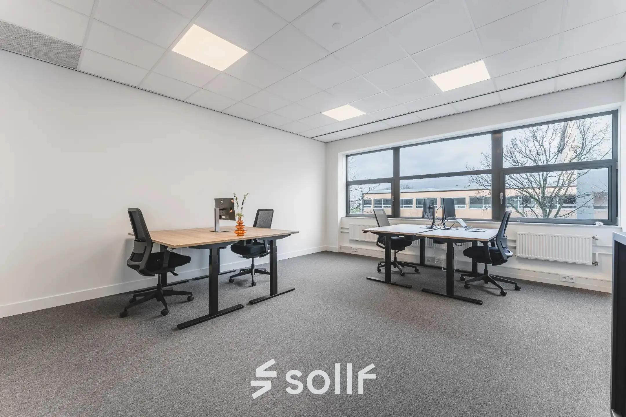 Office space for rent at Veluwezoom 15, Almere Stad featuring large windows, modern desks, and office chairs, ideal for workspace rental.