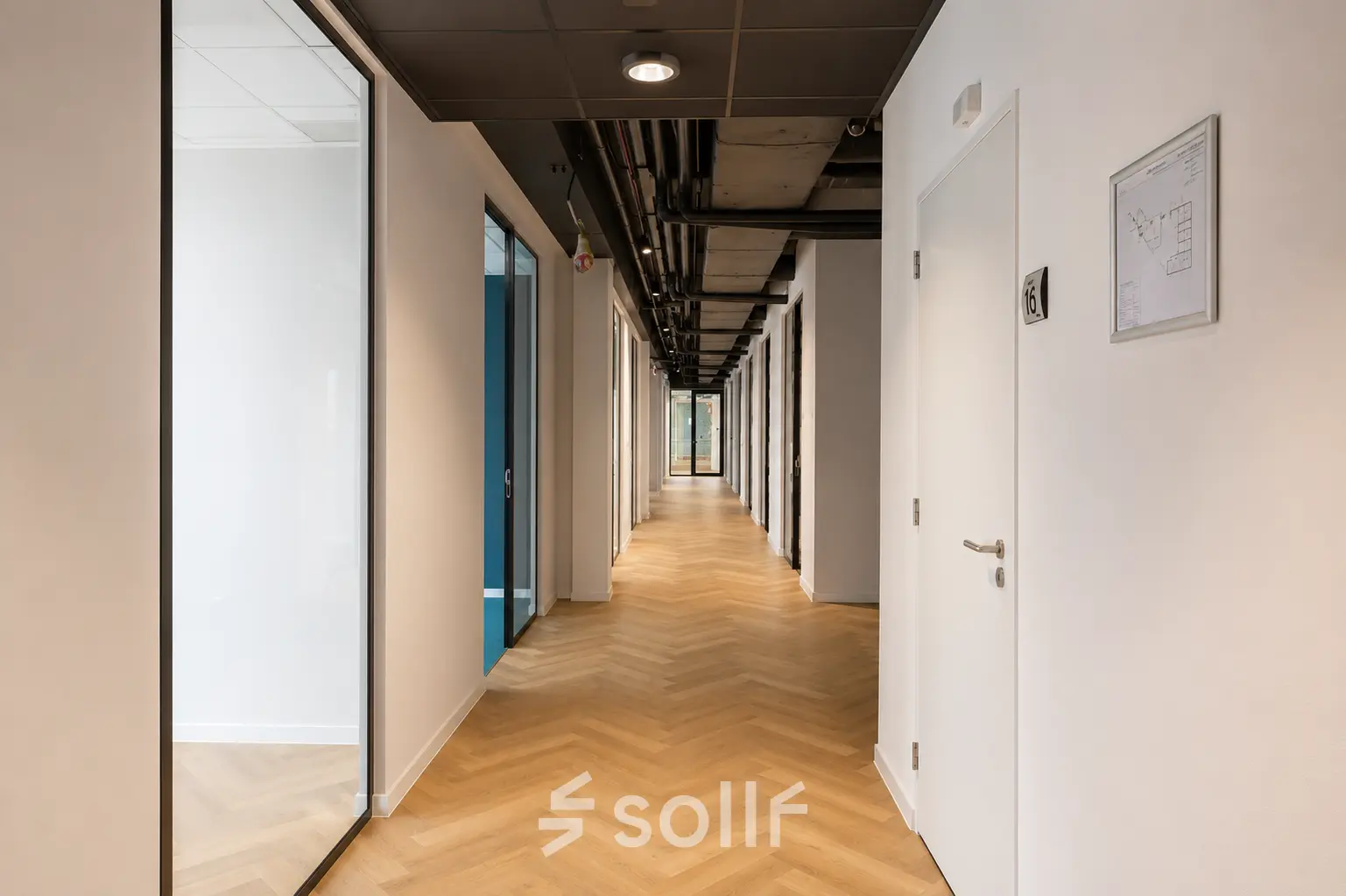 Bright corridor at Veluwezoom 15 in Almere Stad offering access to various office spaces available for rent.