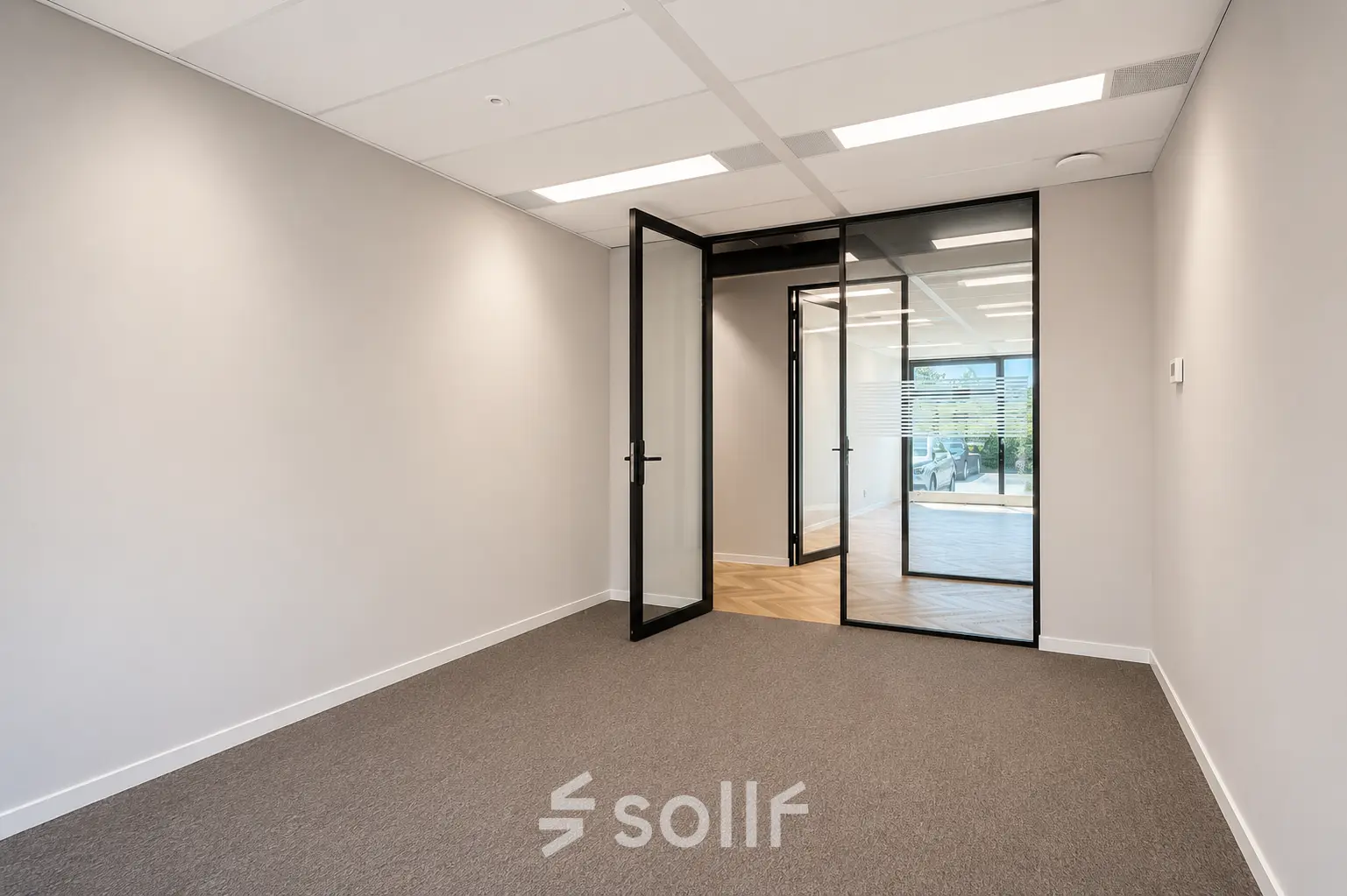 Unfurnished office space at Veluwezoom 15, Almere Stad, with glass walls, high ceilings, and ample natural light, available for rent.