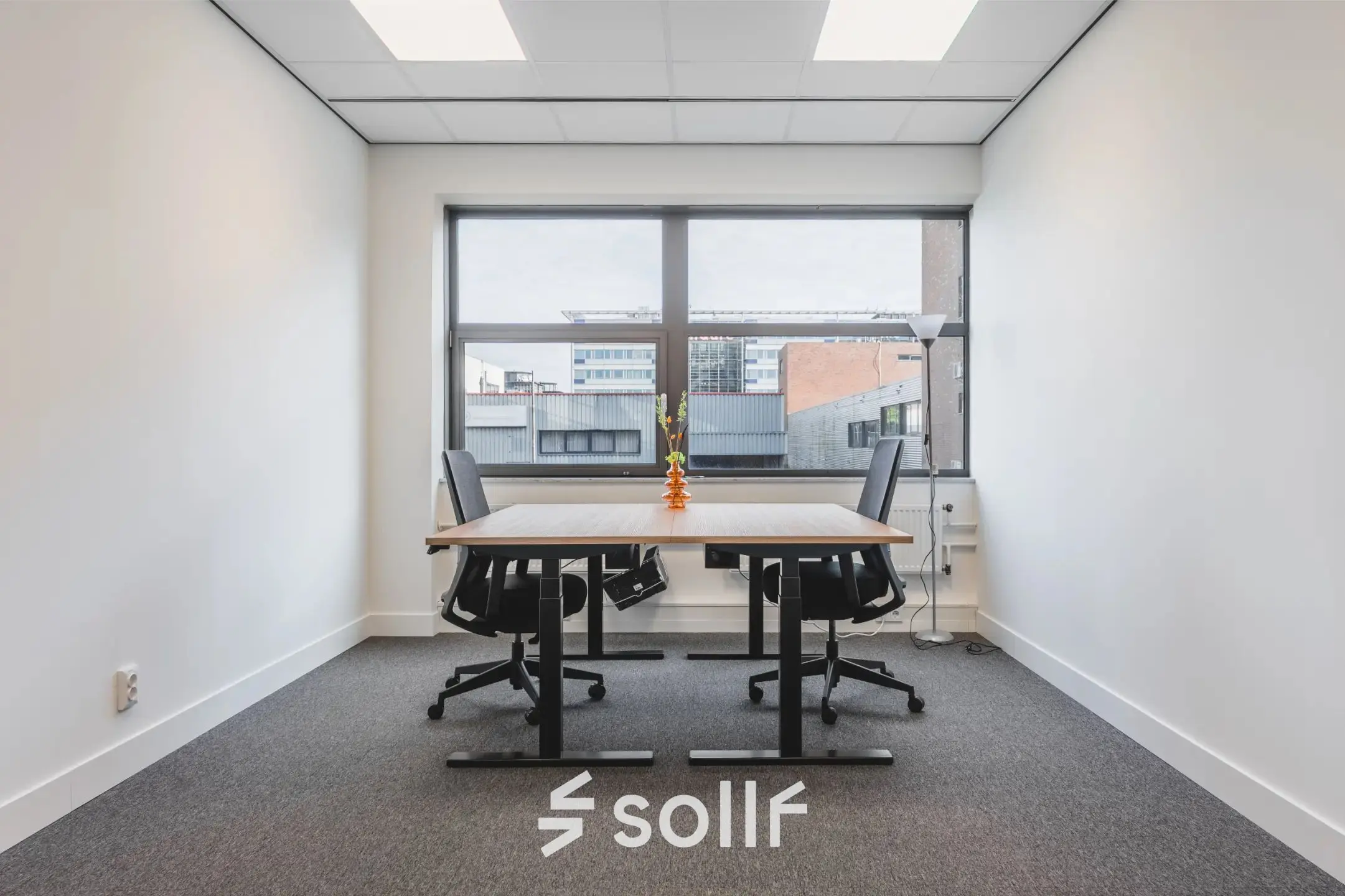 Interior office space at Veluwezoom 15 in Almere Stad, featuring a furnished workspace with a large window. Ideal for office space rental opportunities.