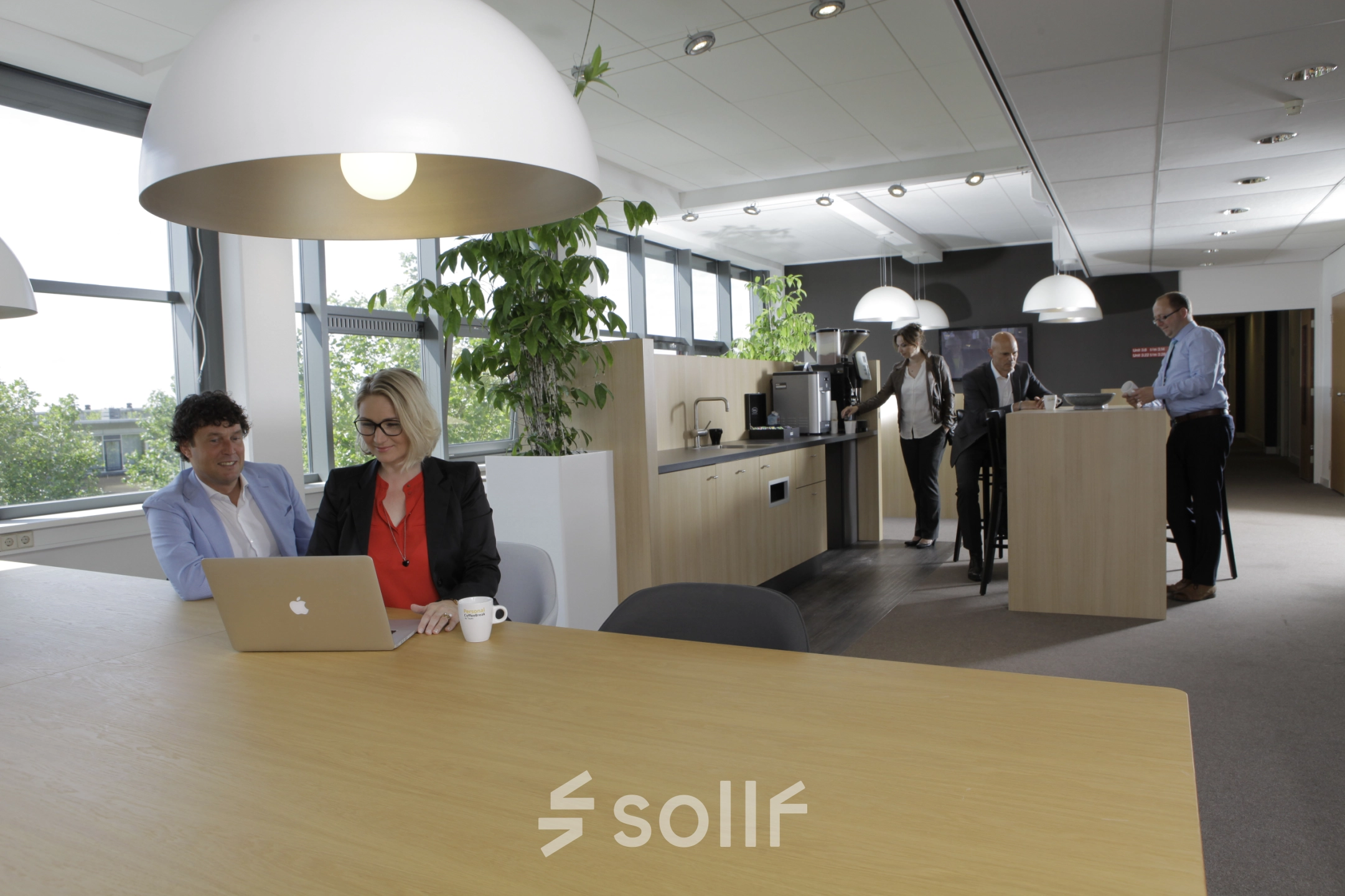 Modern office at Europalaan 16, Alphen aan den Rijn, featuring professionals discussing projects and a collaborative workspace ideal for office space rental.