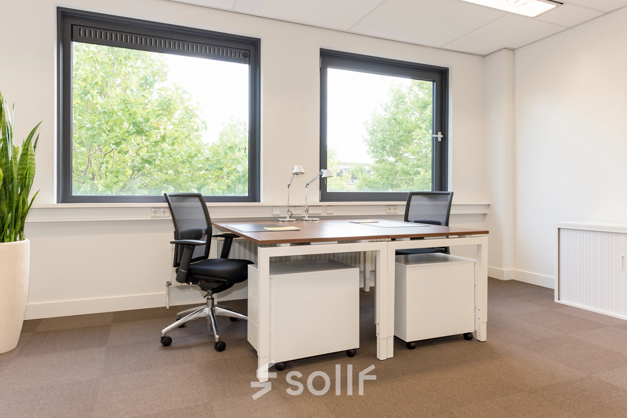 Bright office space with large windows and two desks, available for rent at Europalaan 16, Alphen aan den Rijn.