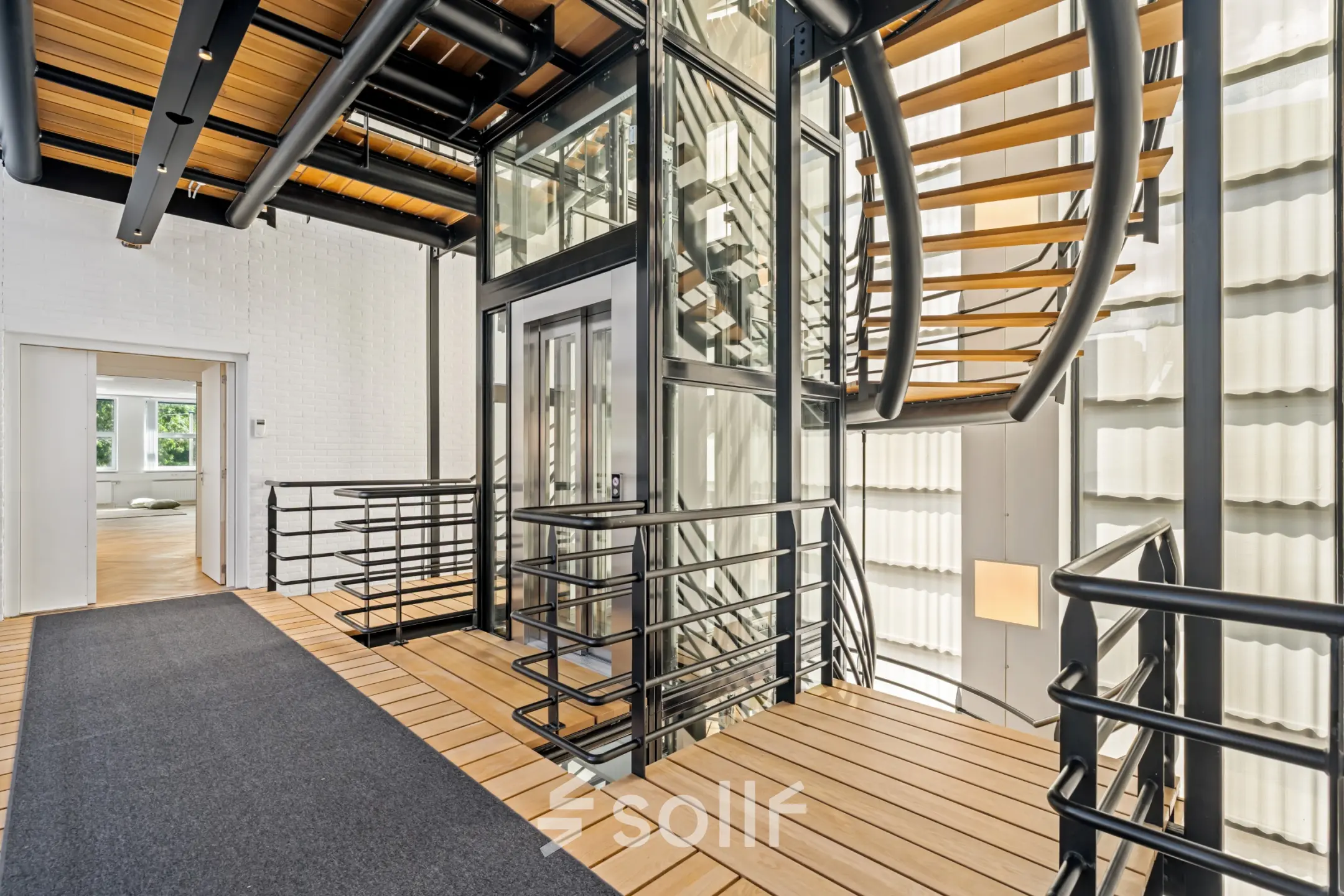 Modern entrance of an office space at Maanlander 43, Amersfoort Calveen, featuring a sleek staircase and an elevator, offering an inviting environment for office space rental.