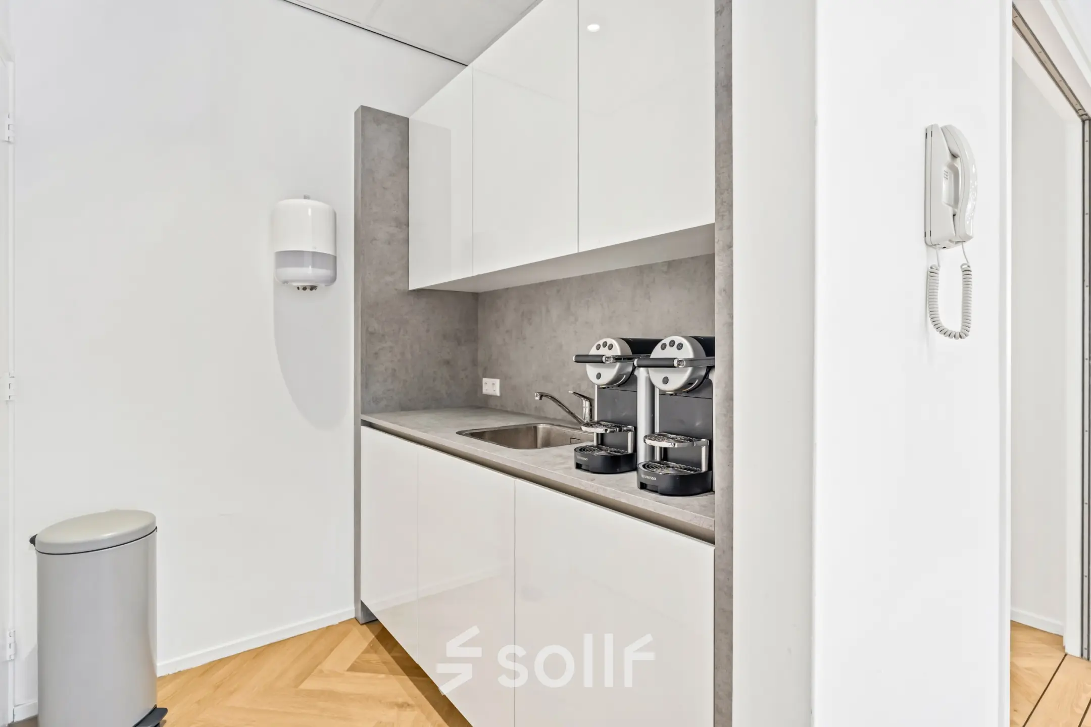 Compact kitchenette with a countertop, sink, and two coffee machines, ideal for break times in this office space rental at Maanlander 43, Amersfoort Calveen.