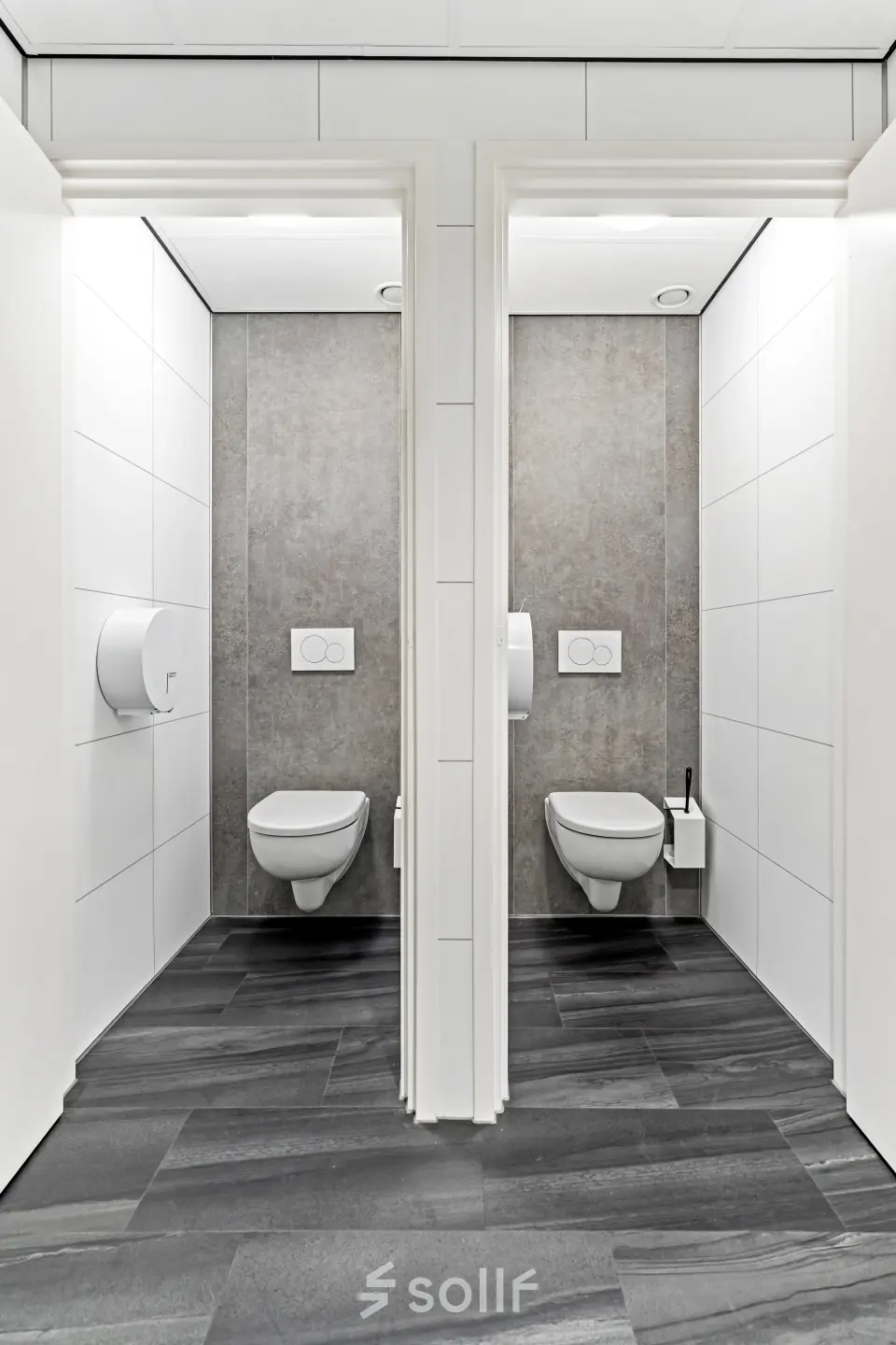 Modern restroom facilities featuring sleek tiled flooring and contemporary designs at Maanlander 43, Amersfoort Calveen, ideal for office space rental.