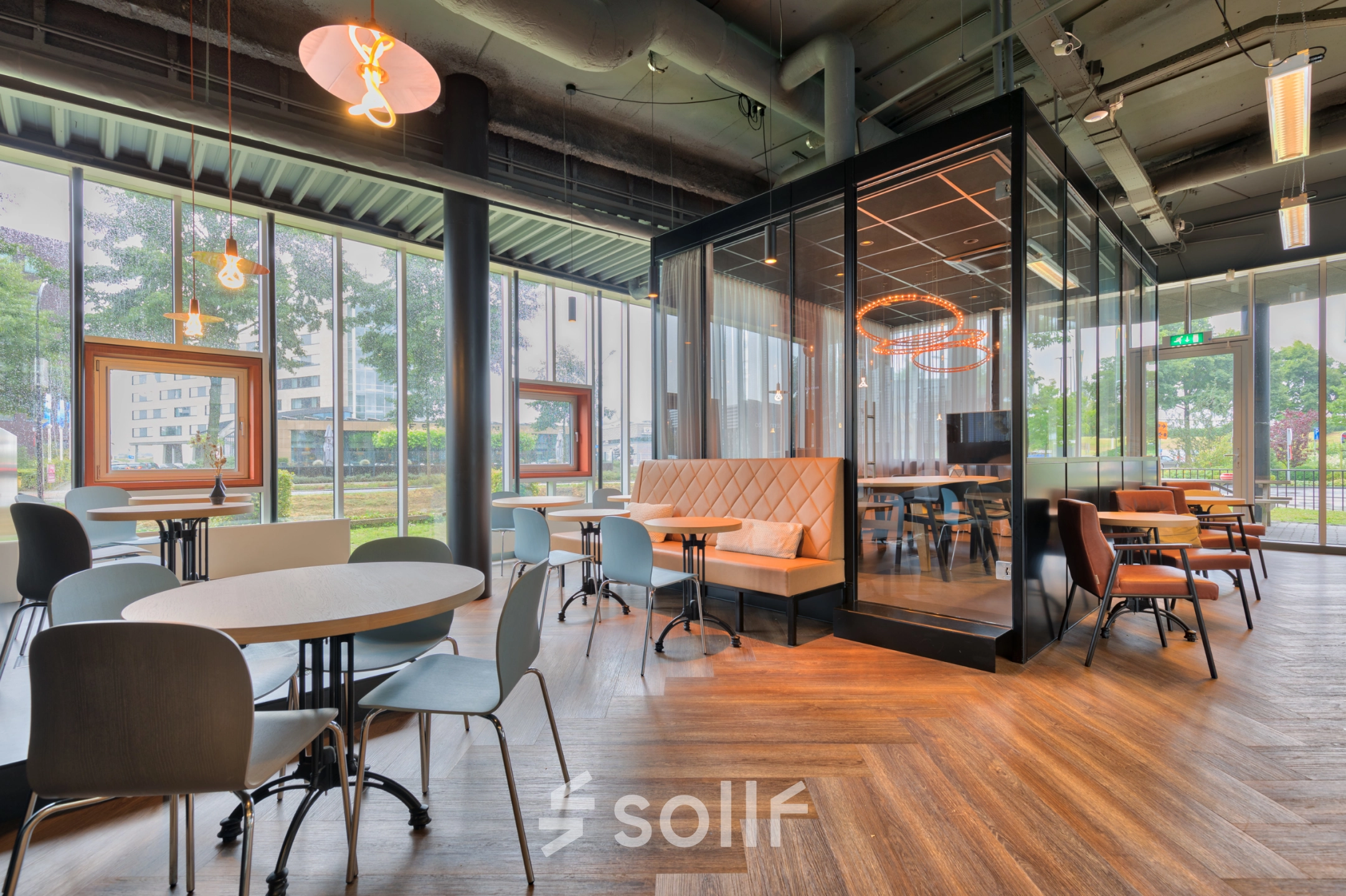 Modern furnished office space for rent at Maanlander 47 in Amersfoort Calveen, featuring elegant seating areas with large windows and contemporary lighting.