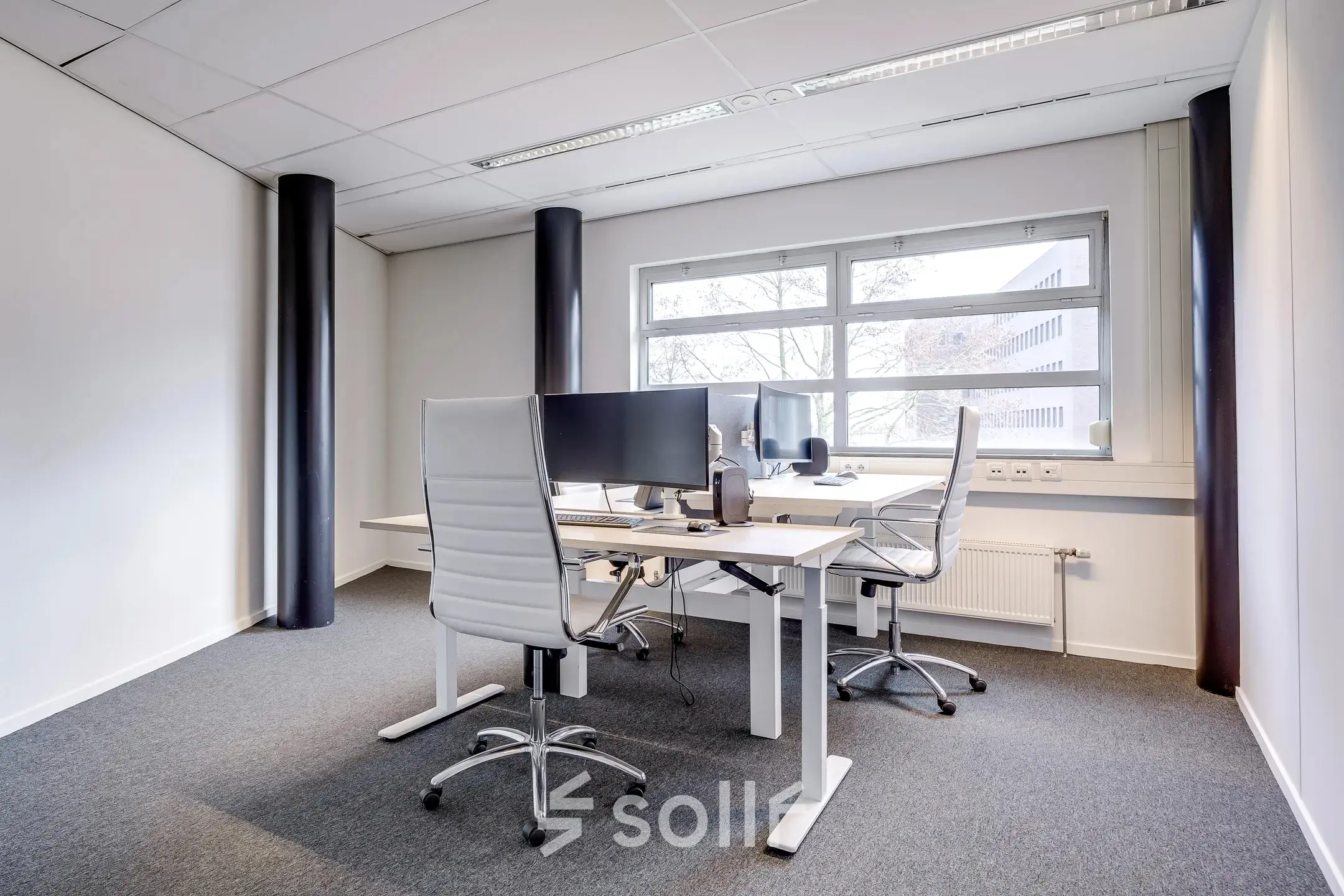 Modern office space rental at Maanlander 47, Amersfoort Calveen, featuring two desks with monitors and chairs, ideal for rent office space.