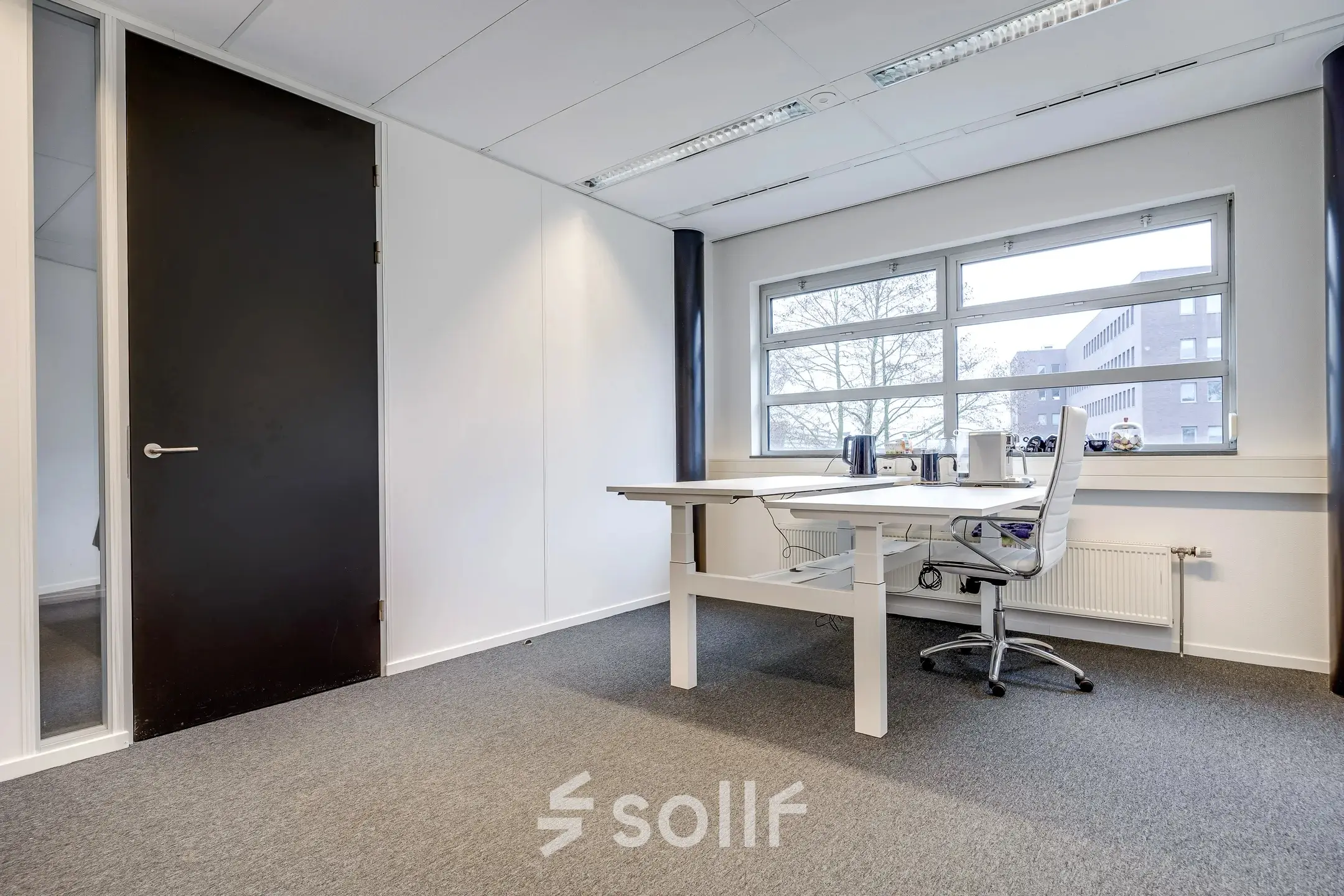 Bright office space for rent at Maanlander 47, Amersfoort Calveen, featuring a large window, desk, and chair, ideal for professionals seeking office space rental.