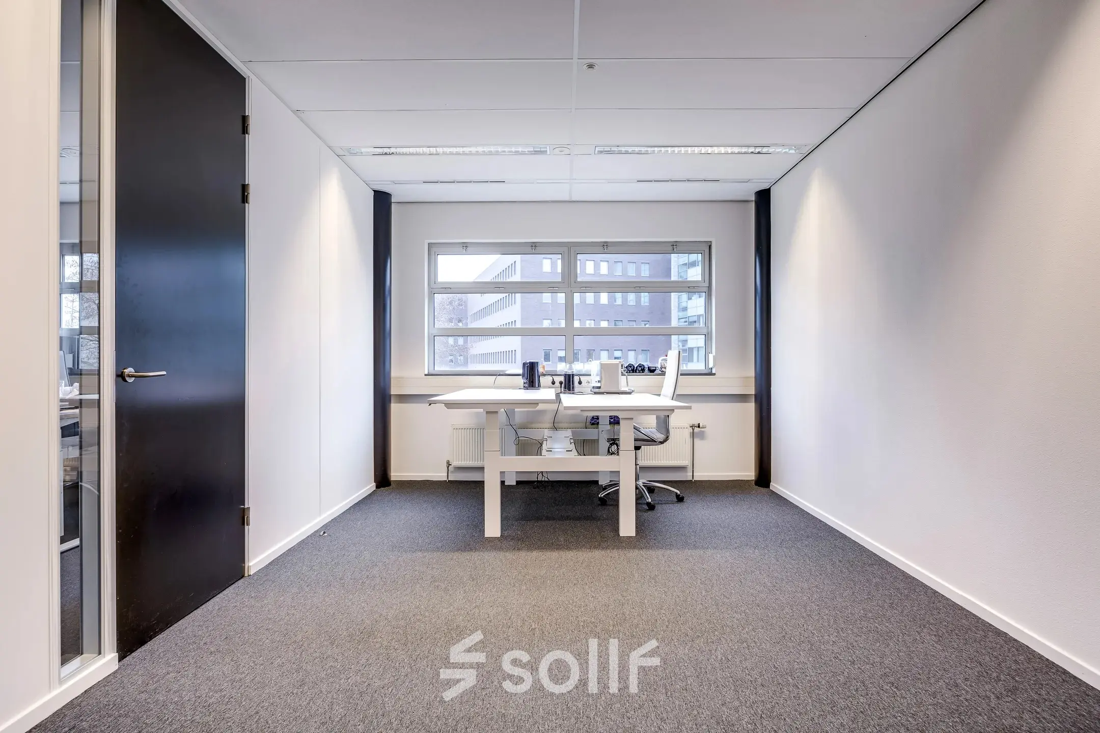 Bright office space at Maanlander 47 in Amersfoort Calveen, featuring a clean, modern design with a window offering natural light. A perfect office space rental option for your business needs.