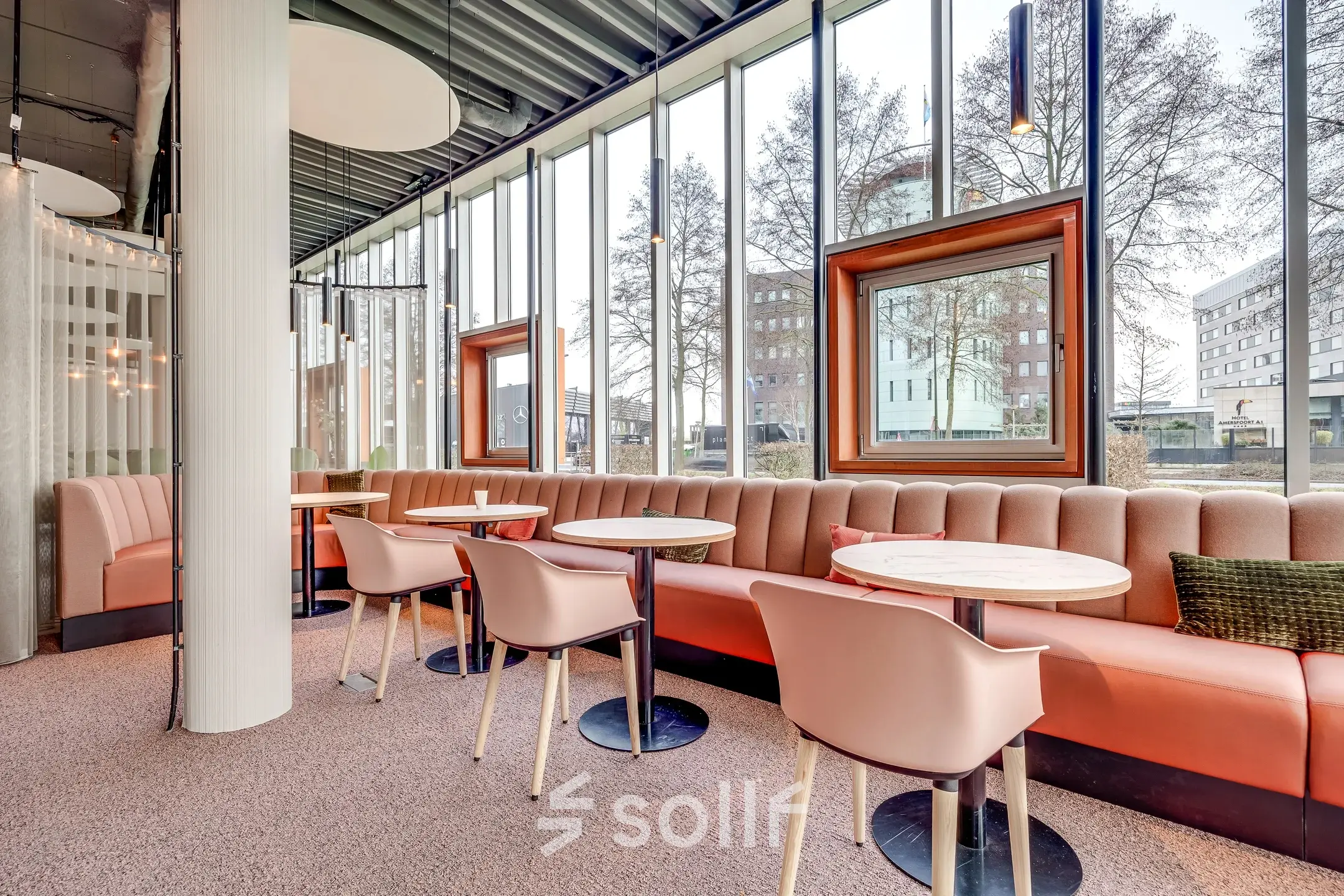 Bright office space with modern seating and large windows at Maanlander 47, Amersfoort Calveen, ideal for office space rental.