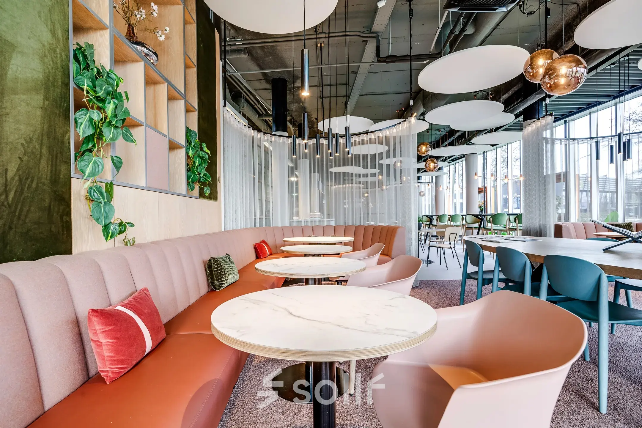 Furnished office space for rent at Maanlander 47, Amersfoort Calveen, featuring modern seating with stylish lighting and greenery.