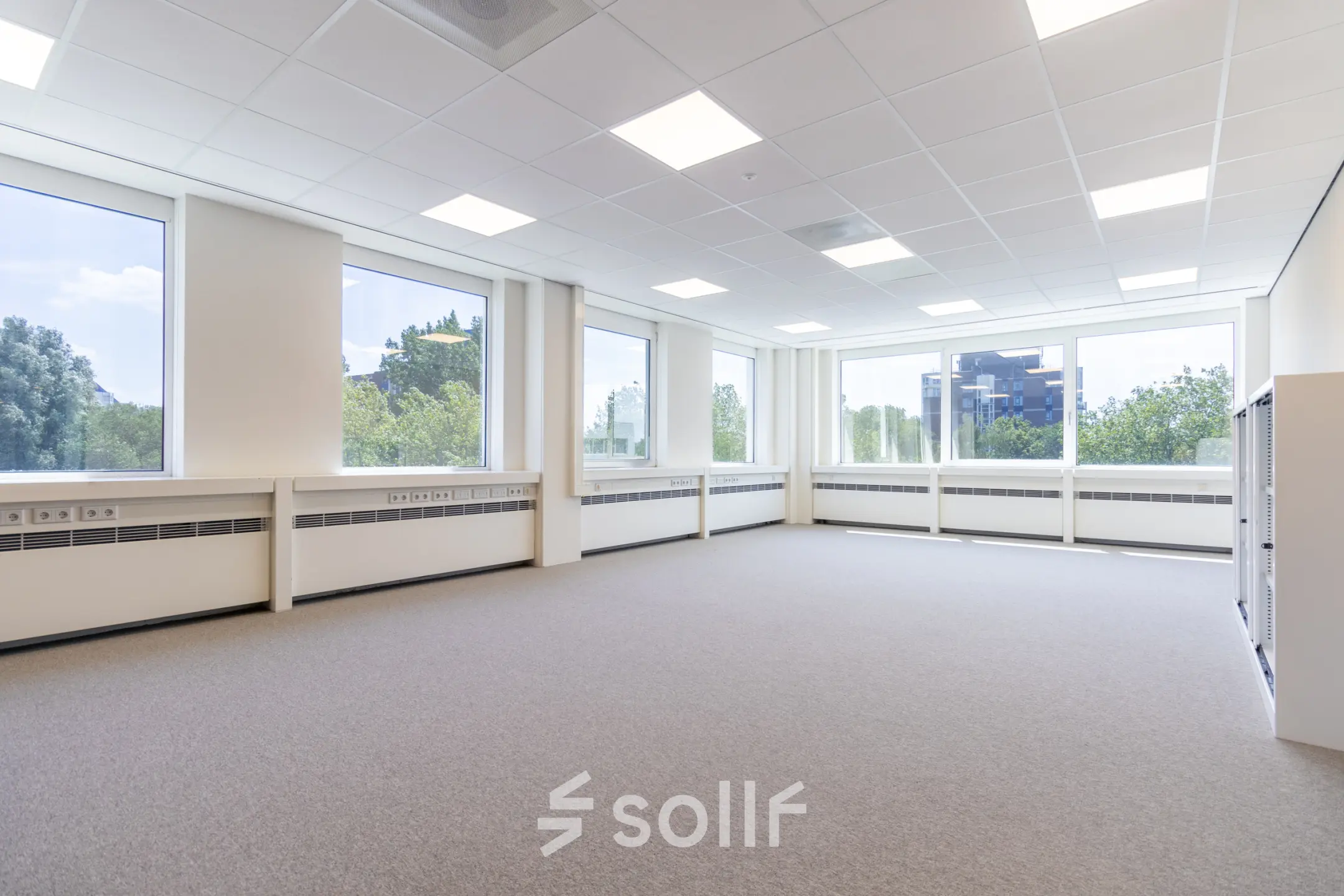 Unfurnished, well-lit office space at De Gondel 1, Amstelveen, showcasing large windows with a view, available for rent.
