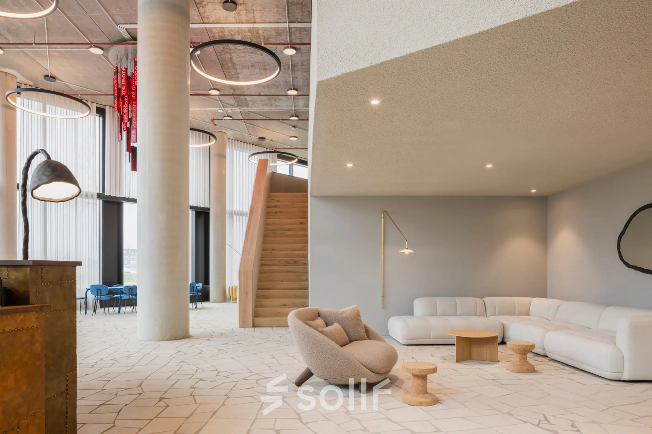 Modern office space featuring stylish lounge area with contemporary seating and ambient lighting at Amsterdam Amstel Business Park, ideal for office space rental.