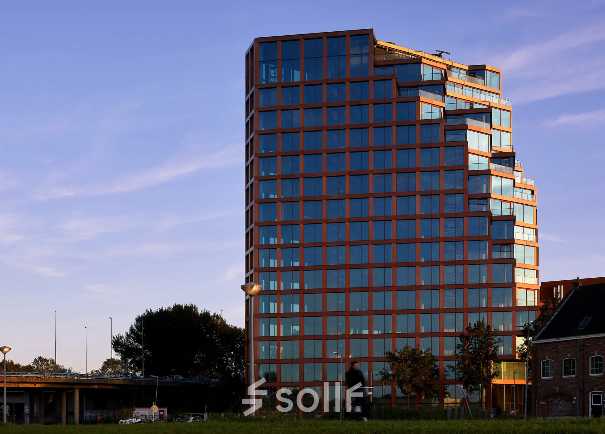 Modern office building located at H.J.E. Wenckebachweg 230-258 in Amsterdam Amstel Business Park, characterized by a sleek glass facade. Ideal for those seeking office to rent with panoramic views of the city.