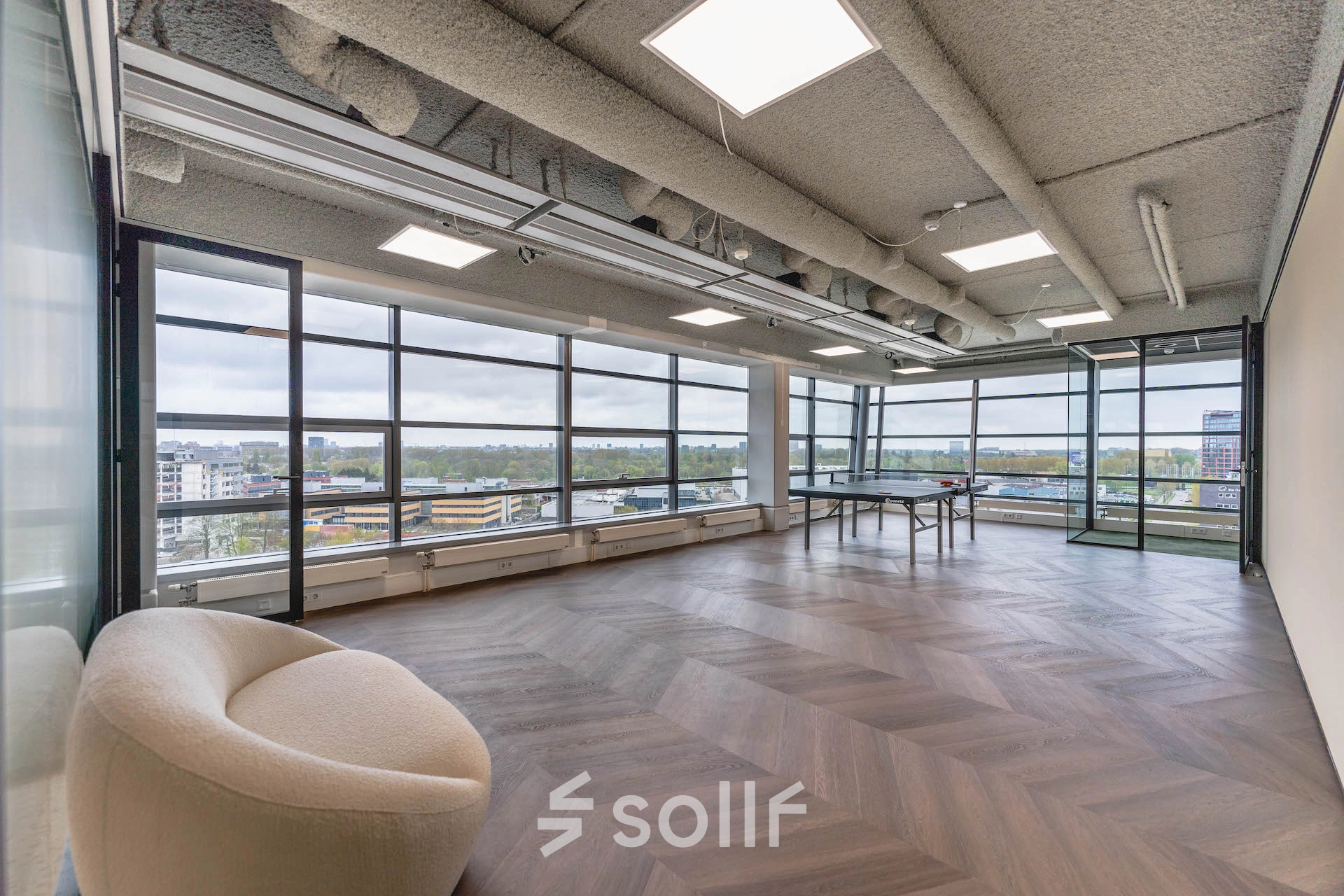 Spacious office space with large windows in Amsterdam Amstel Business Park, available for rent. The room offers natural light and scenic views, ideal for office space rental.