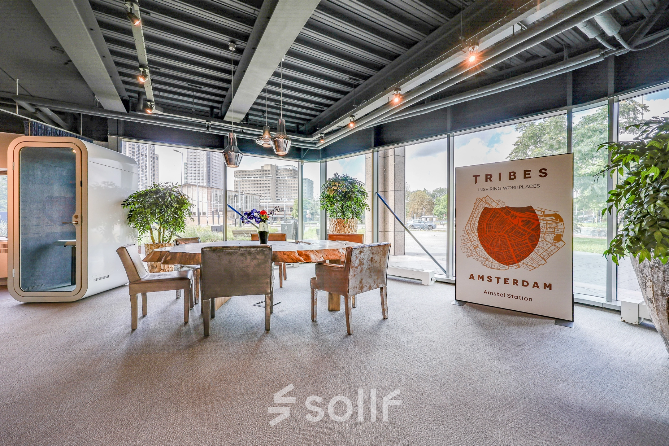 Modern office space with large windows and a meeting area at Prins Bernhardplein 200, ideal for office space rental in Amsterdam Amstel.