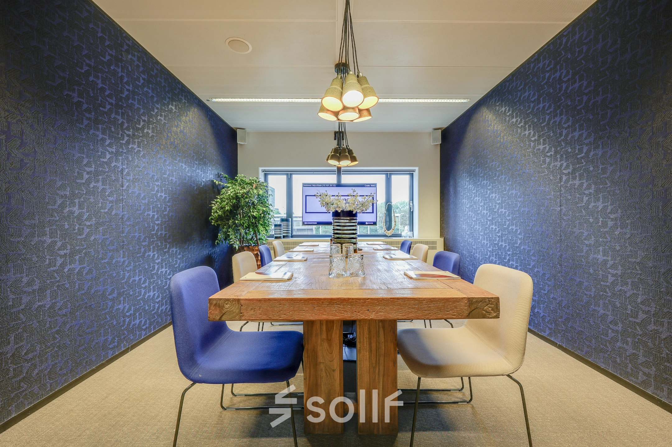 Modern conference room with wooden table and upholstered chairs, available for office space rental at Prins Bernhardplein 200, Amsterdam Amstel.