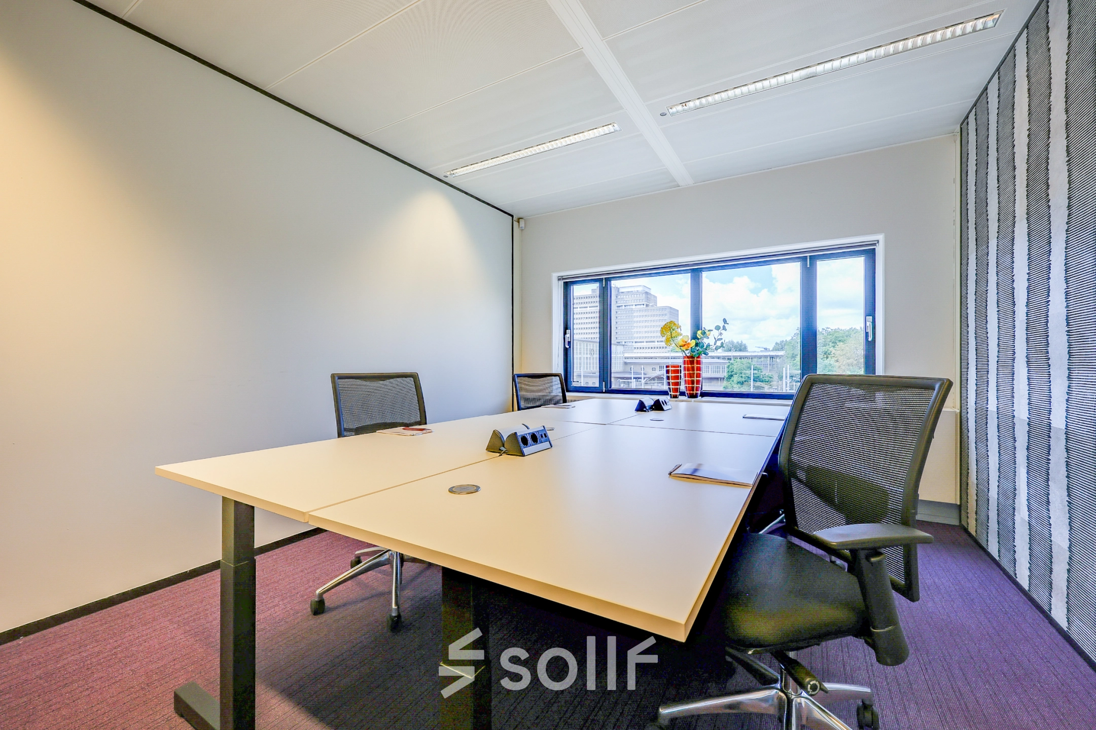 Bright office space with desks and chairs, featuring a window view at Prins Bernhardplein 200, Amsterdam Amstel. Ideal for office space rental.