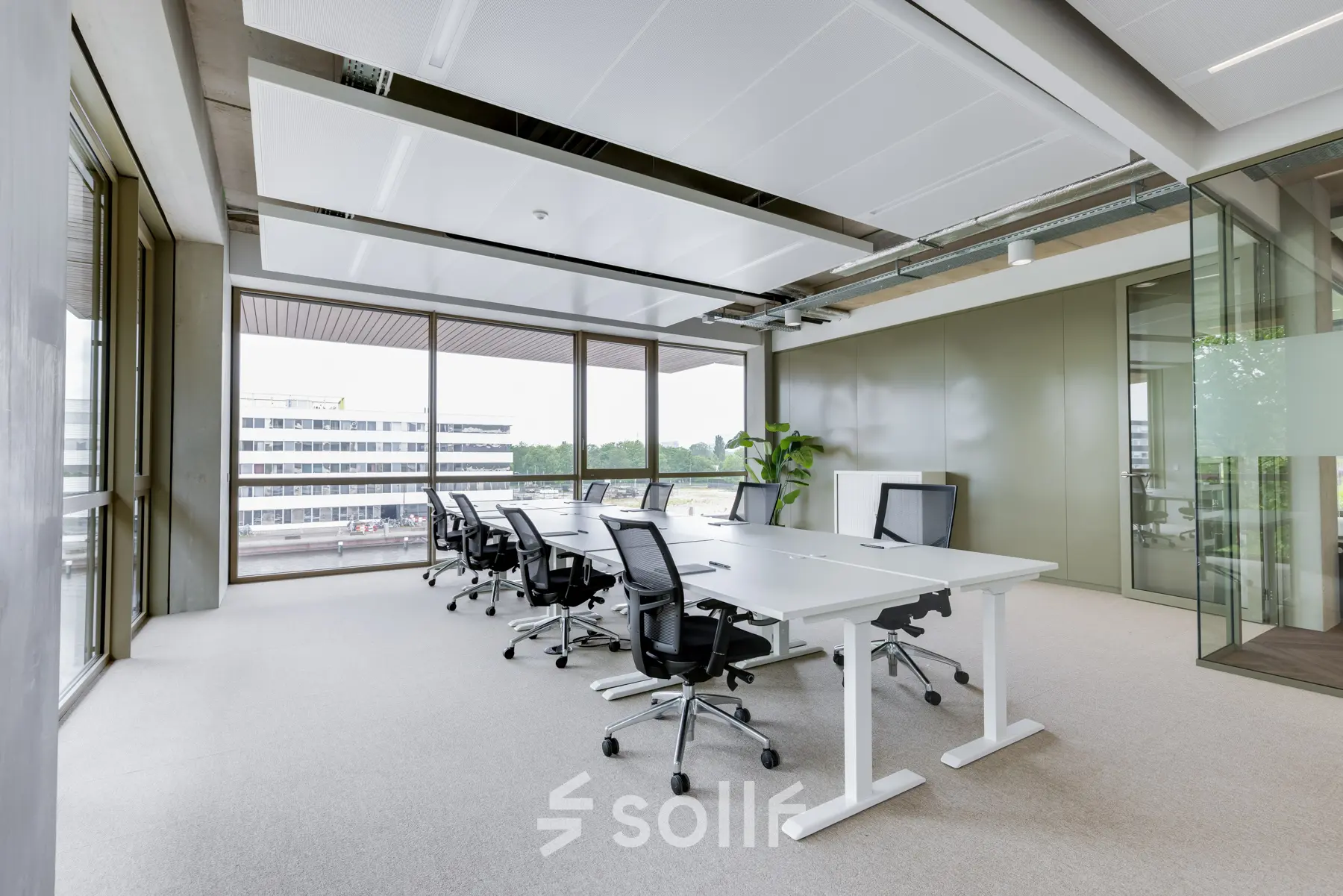 Bright office space with modern furnishings and large windows at Willem Fenengastraat 16, Amsterdam Amstel, ideal for office space rental.