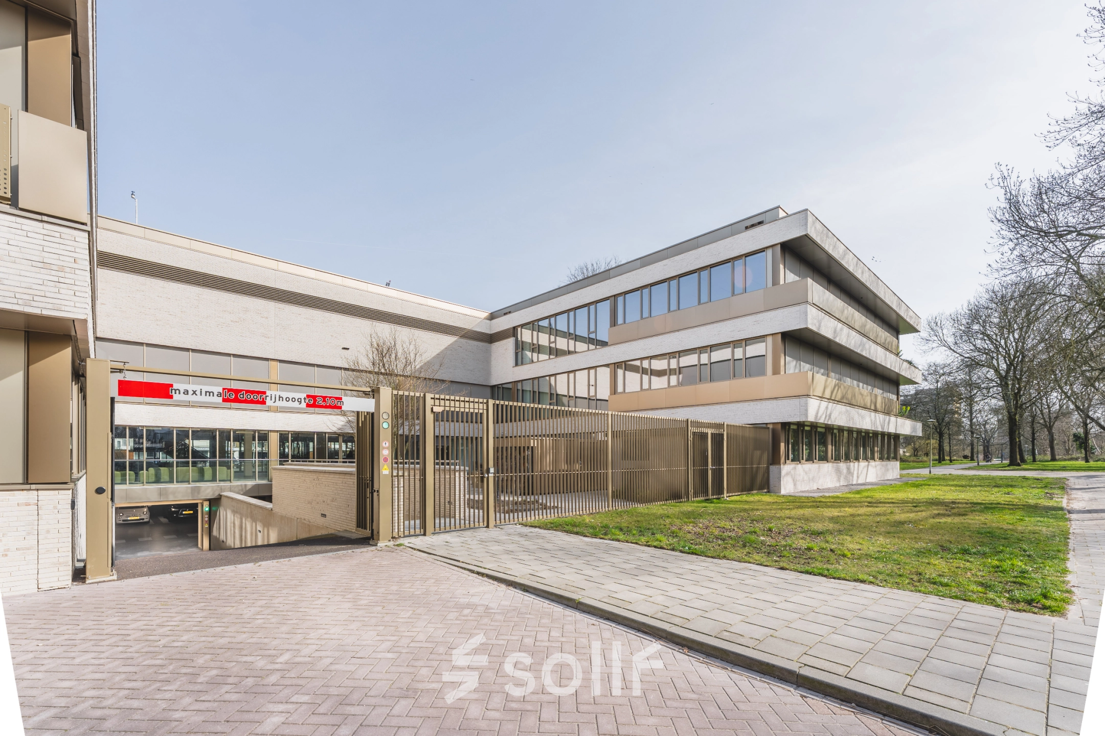 Exterior view of office space for rent at Walborg 2A, Amsterdam Buitenveldert, featuring a modern building with greenery.
