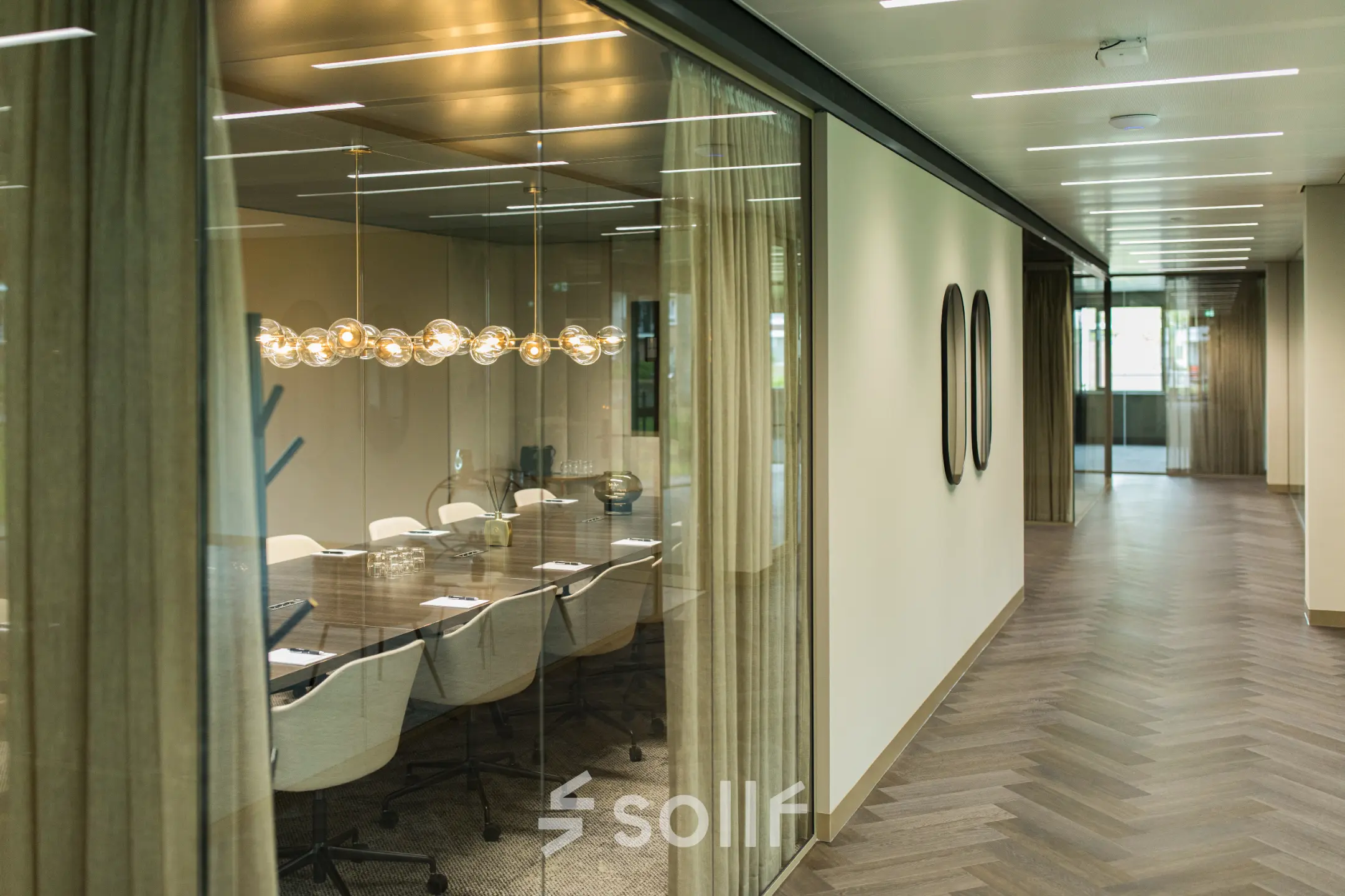 A modern meeting room at Walborg 2A, Amsterdam Buitenveldert, featuring a long table and comfortable chairs, ideal for office space rental.