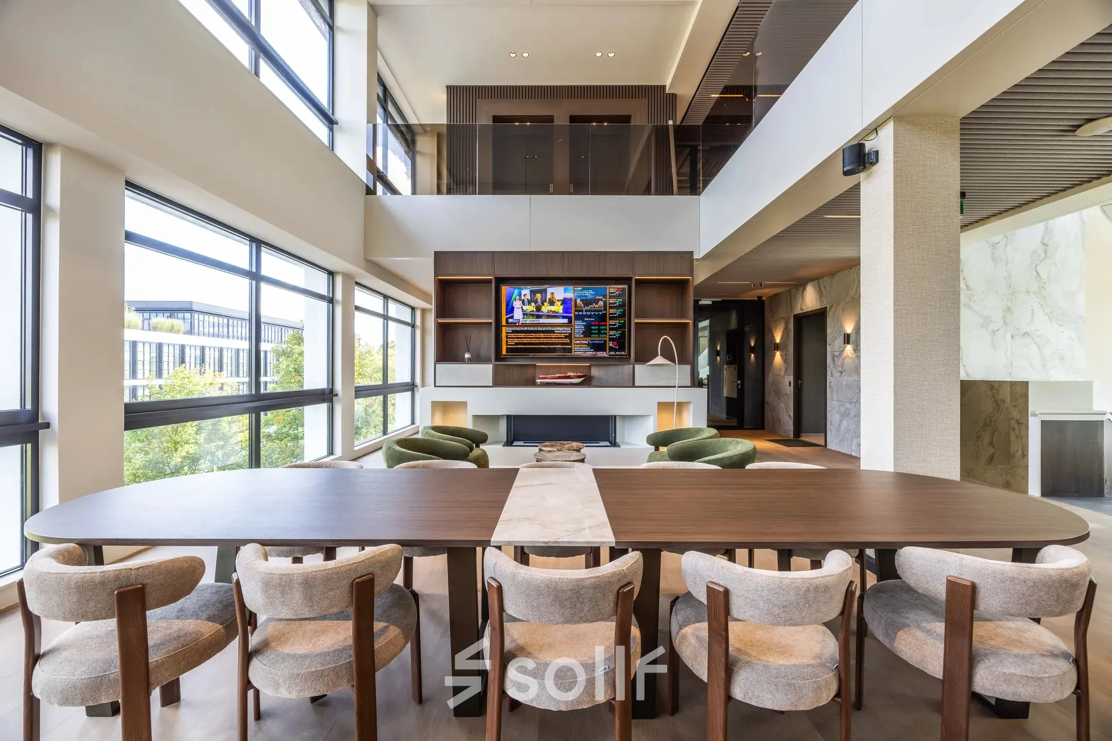 Modern, furnished office space for rent at Zwaansvliet 1, Amsterdam Buitenveldert, featuring a spacious conference room with large windows and a stylish table surrounded by comfortable chairs.