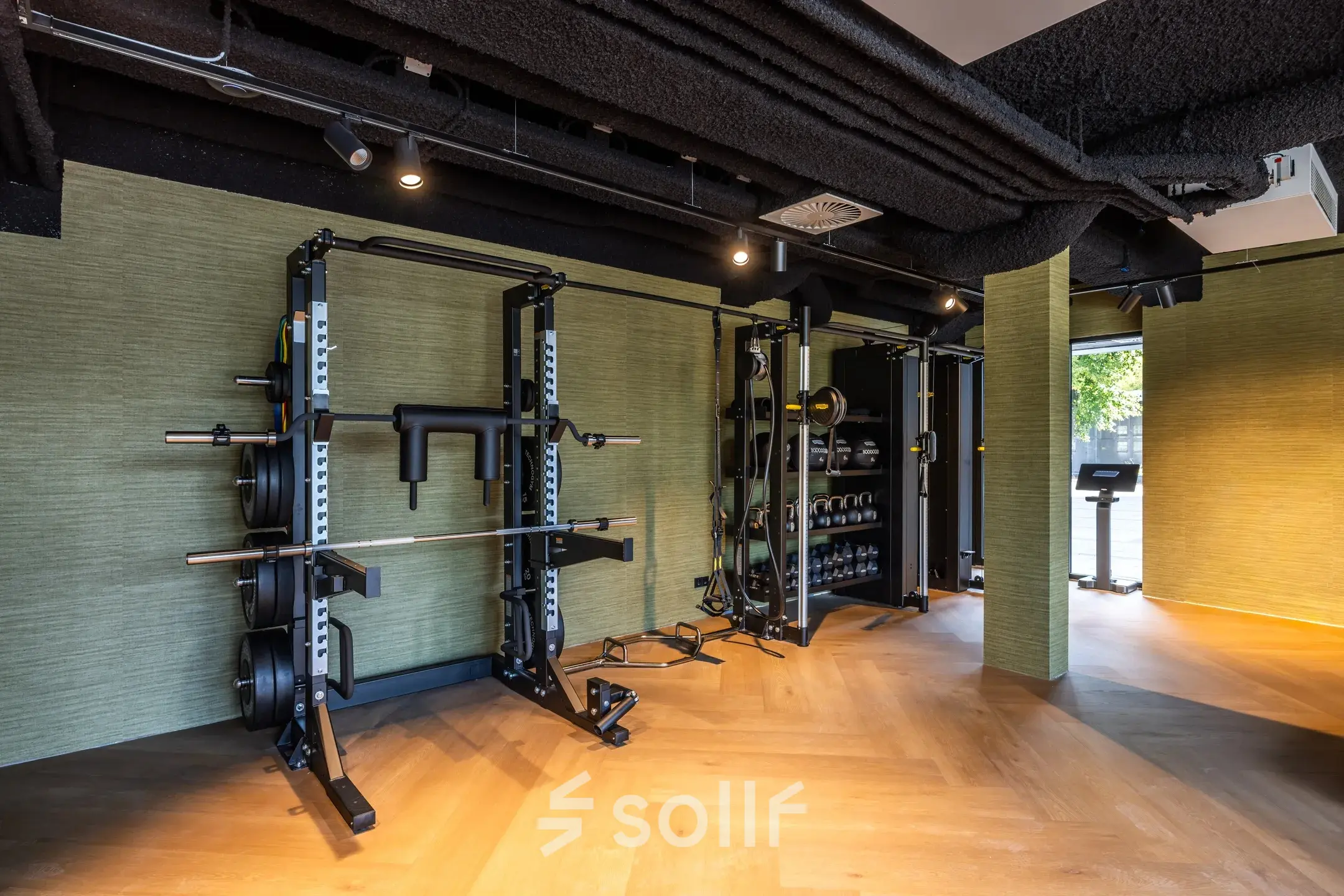 A furnished exercise area perfect for office space rental at Zwaansvliet 1, Amsterdam Buitenveldert, featuring fitness equipment and wood flooring.