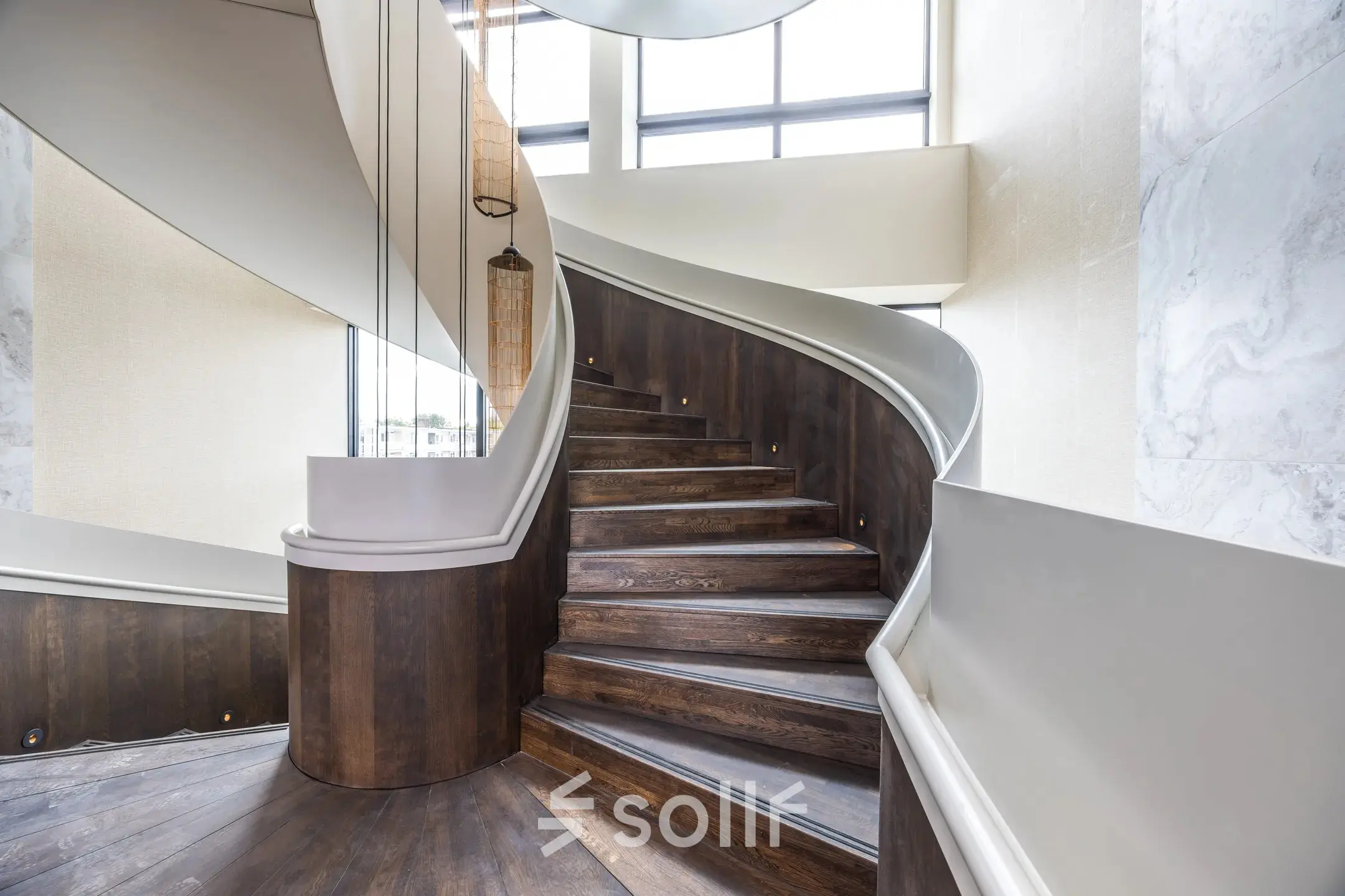 Modern staircase in an Amsterdam Buitenveldert office, showcasing elegant wooden steps and sleek design elements, available for office space rental.
