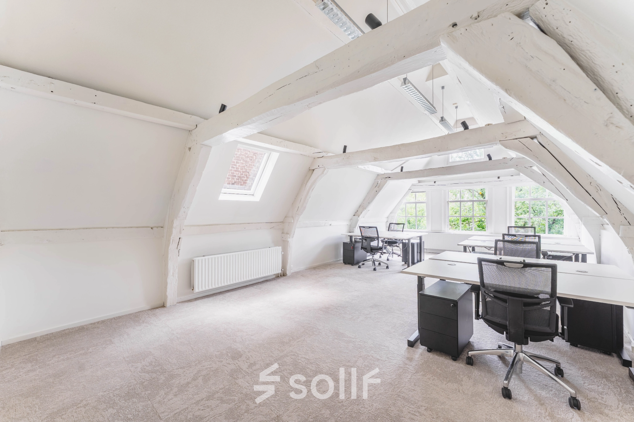 Spacious office for rent at Herengracht 221, Amsterdam Canal Belt, featuring large windows and multiple desks with chairs for office space rental.