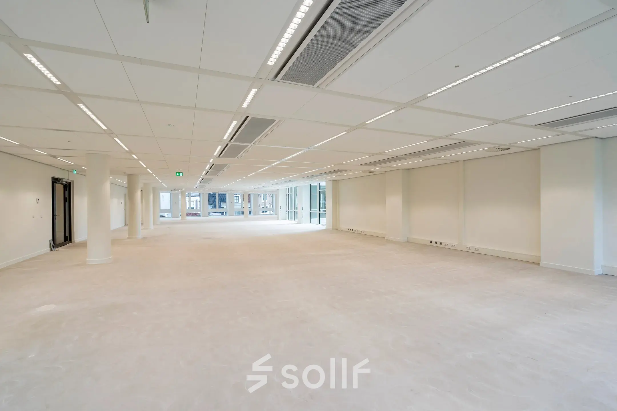 Spacious unfurnished office space available for rent at Herengracht in Amsterdam Canal Belt, featuring bright lighting and large windows.