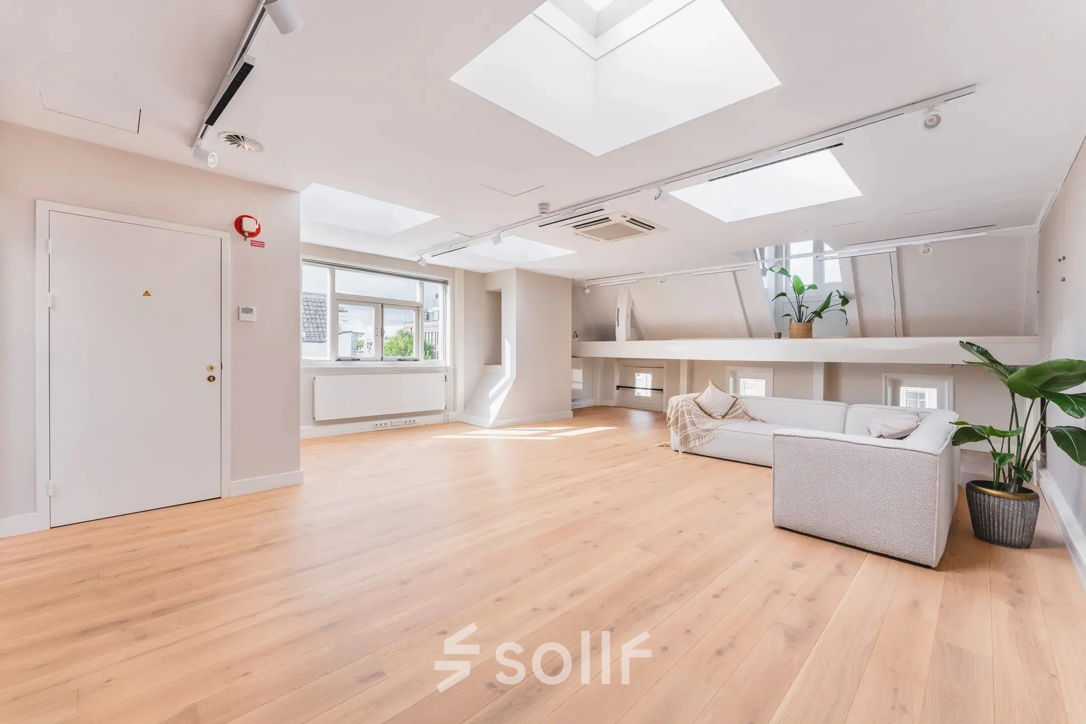 Bright, open-floor office space with skylights and hardwood floors, located in the Amsterdam Canal Belt, perfect for rent office space.
