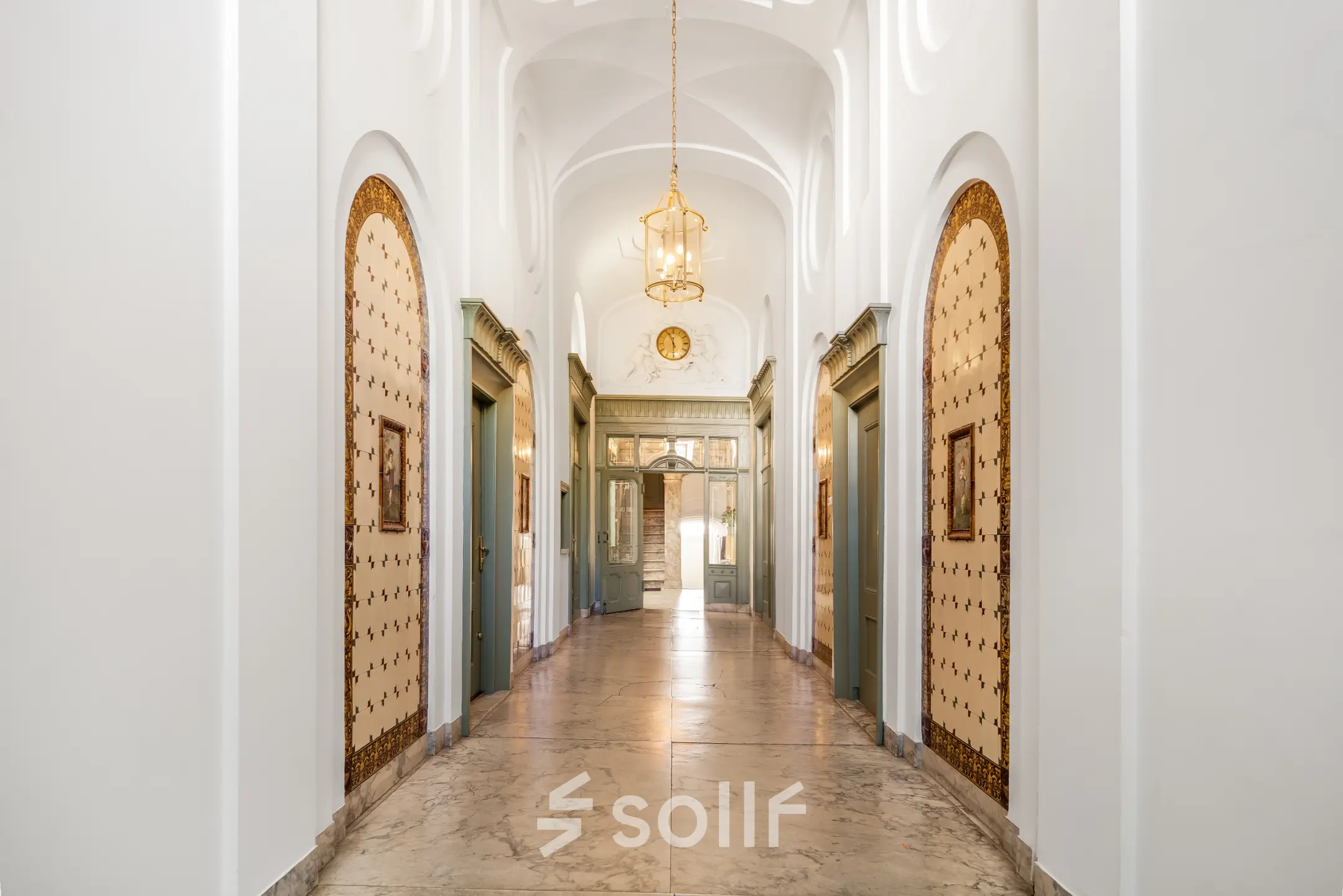 Elegant entrance hallway with classic arches, ornate chandeliers, and vintage decor details at Keizersgracht 261 in Amsterdam Canal Belt, ideal for office space rental.