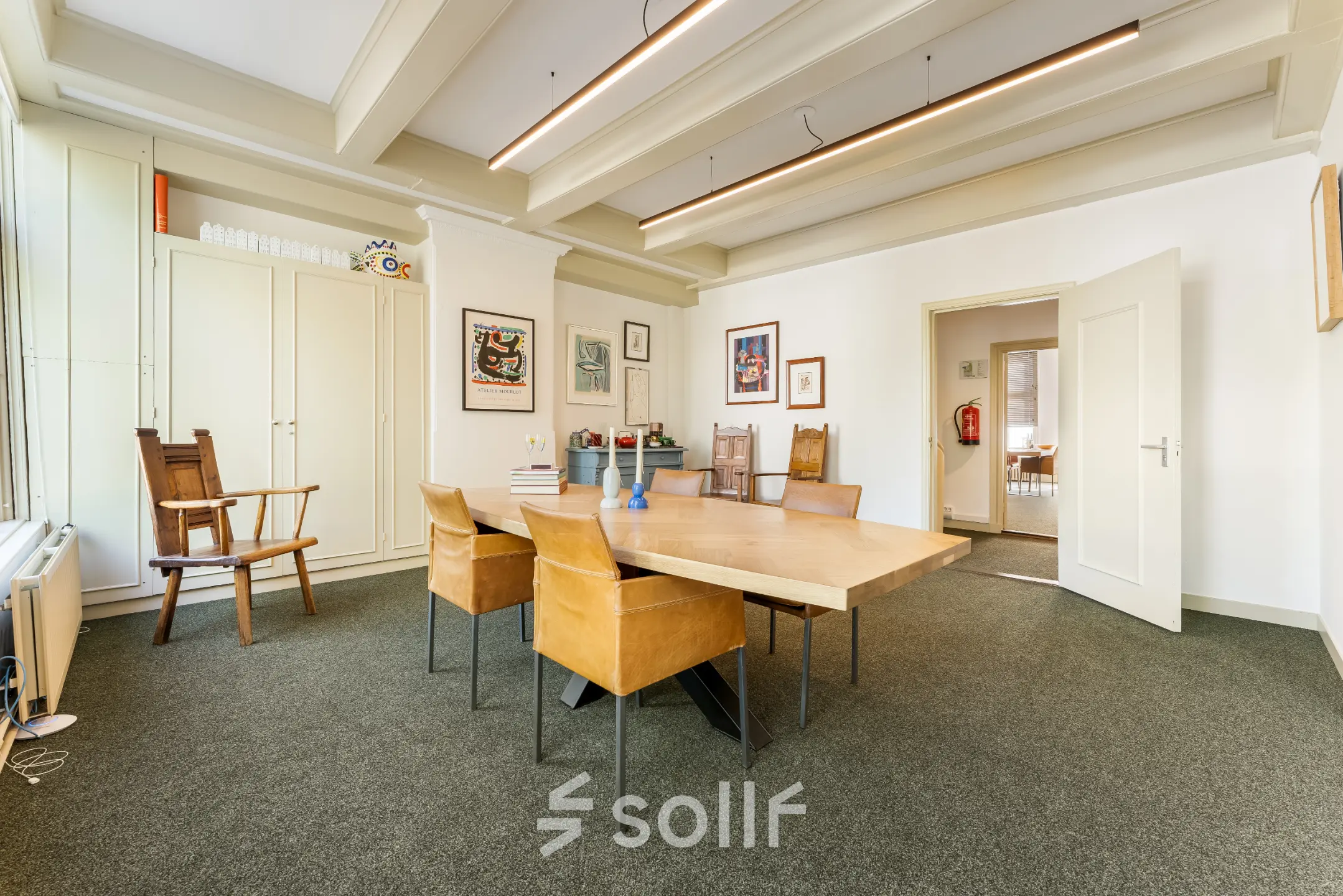 Furnished office space for rent at Keizersgracht 261, Amsterdam Canal Belt, featuring a spacious meeting area with a large wooden table and chairs, ideal for office space rental.