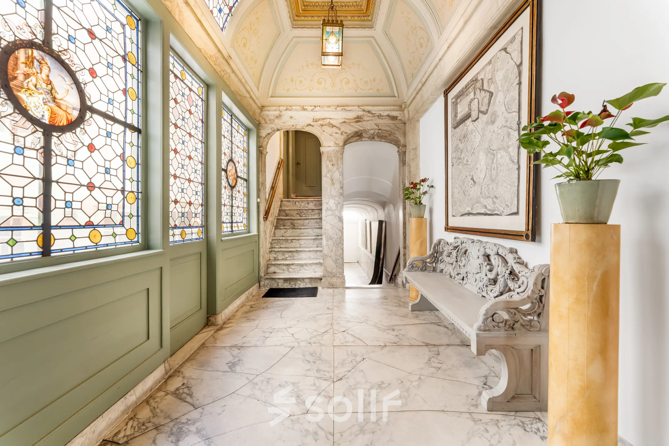 Elegant entrance space with marble flooring and ornate stained glass windows at office to rent on Keizersgracht 261, Amsterdam Canal Belt.