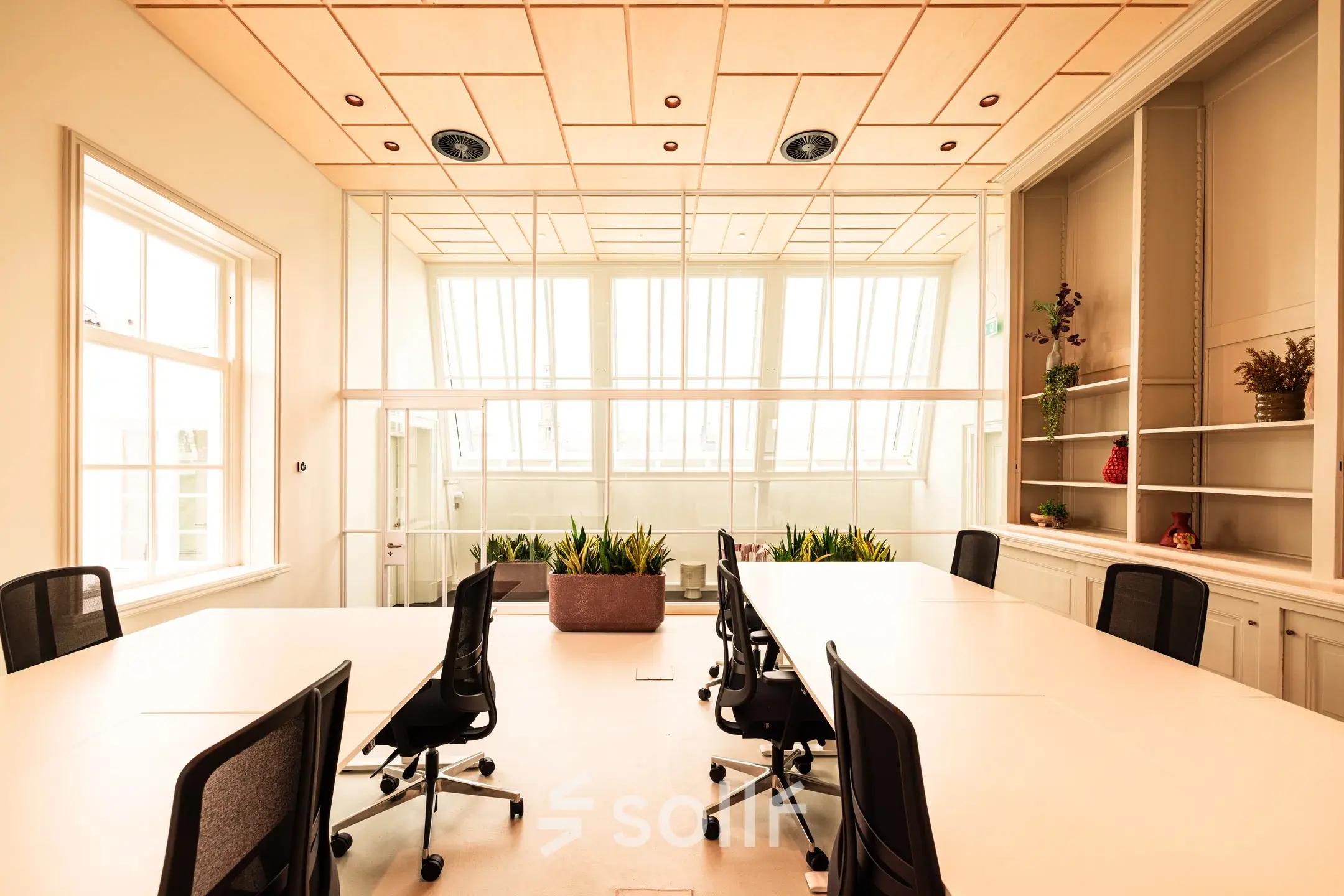 Bright office space with large windows, furnished with desks and chairs, perfect for workspace rental at Keizersgracht 264, Amsterdam Canal Belt.