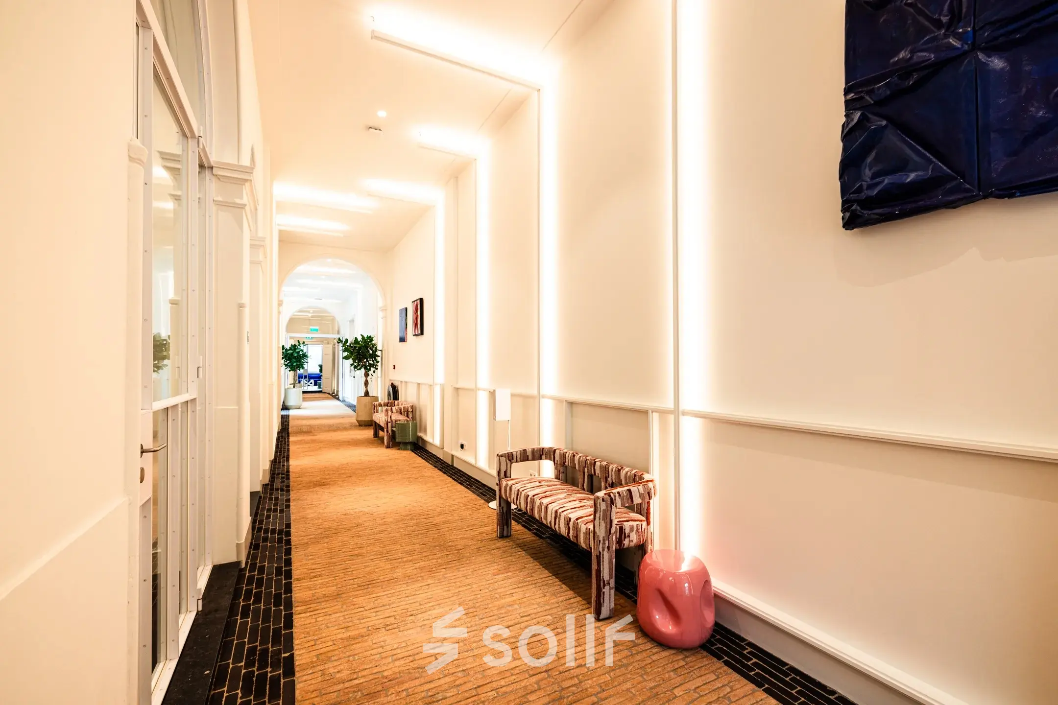 Bright hallway with designer bench and modern lighting at office to rent on Keizersgracht 264, Amsterdam Canal Belt.