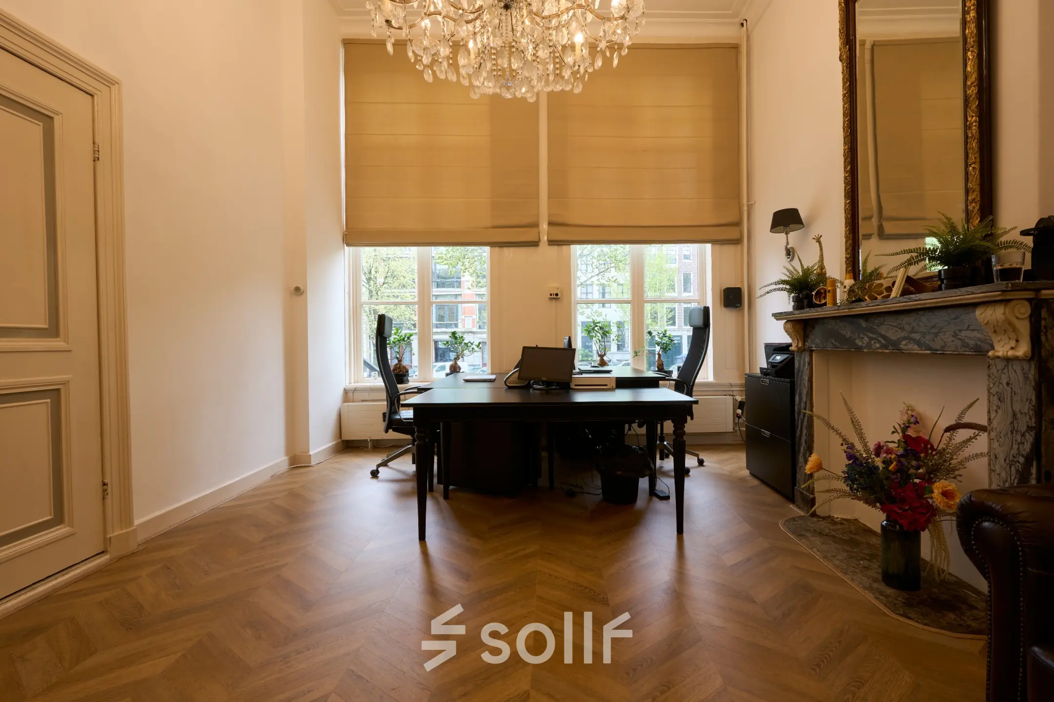 Bright office space with large windows, elegant chandelier, and classic fireplace at Keizersgracht 391A, Amsterdam Canal Belt. Ideal for office space rental with potential for stylish work environment.