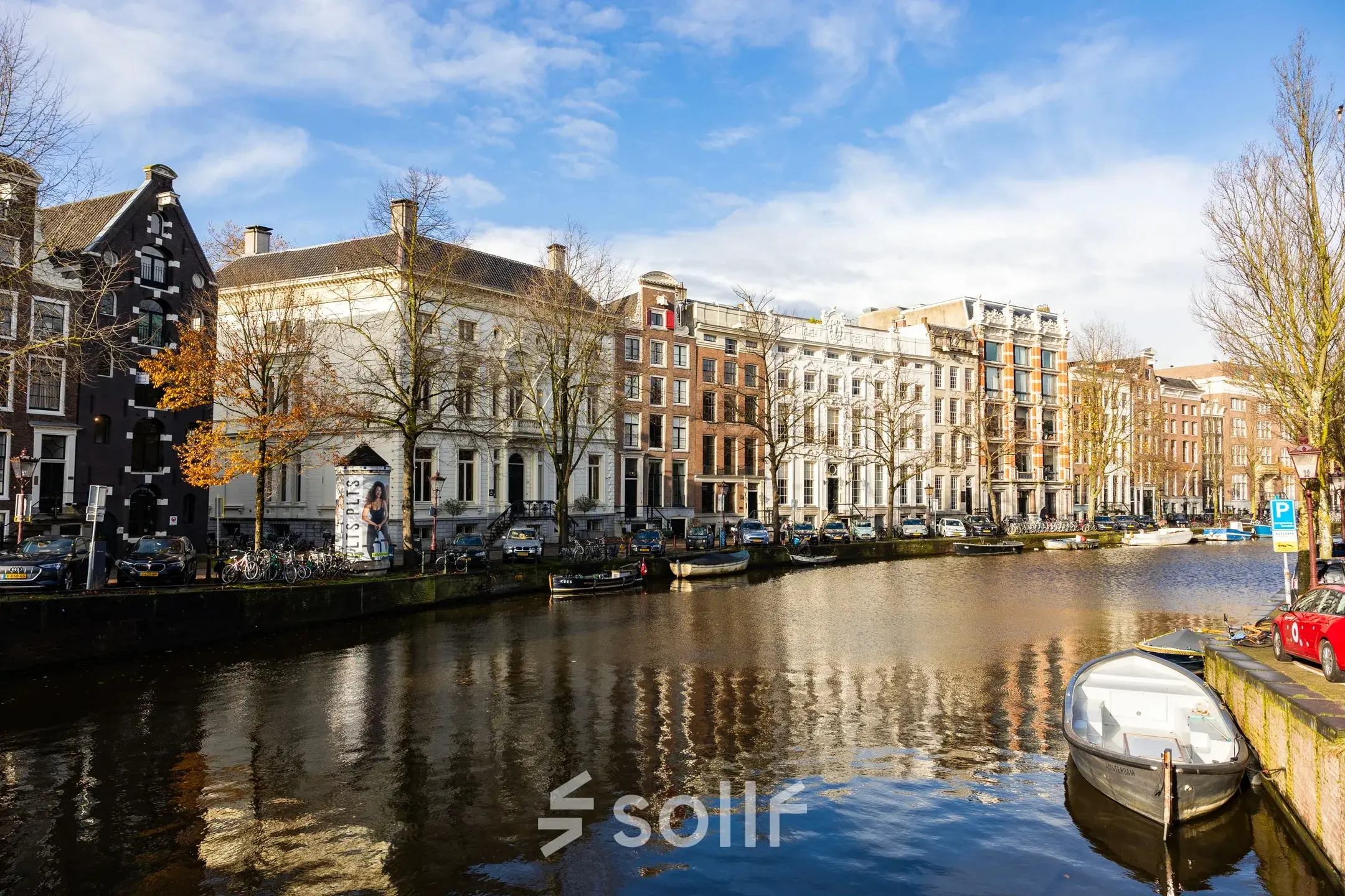A scenic view of the Amsterdam Canal Belt at Keizersgracht 452, showcasing historic buildings along the water.