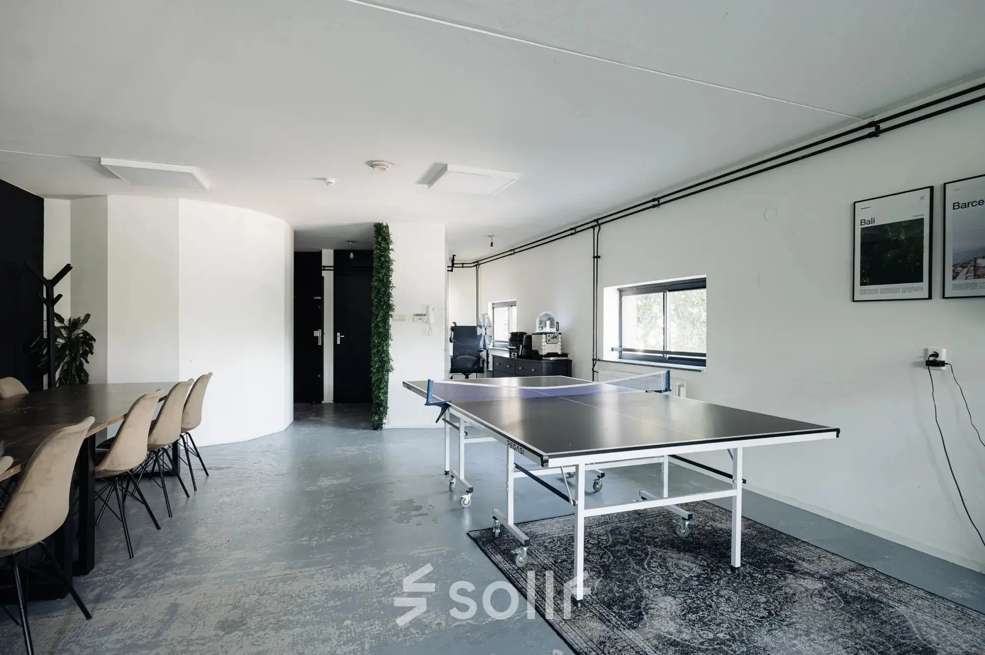 Spacious office area on Weesperstraat 394-396, Amsterdam Canal Belt, featuring a ping pong table and conference table, ideal for office space rental.
