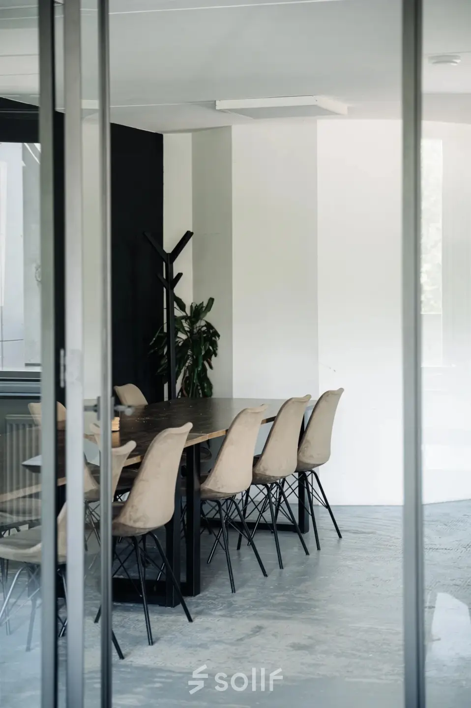 Modern office space with a large wooden table and beige chairs at Weesperstraat 394-396, Amsterdam Canal Belt, available for office space rental.