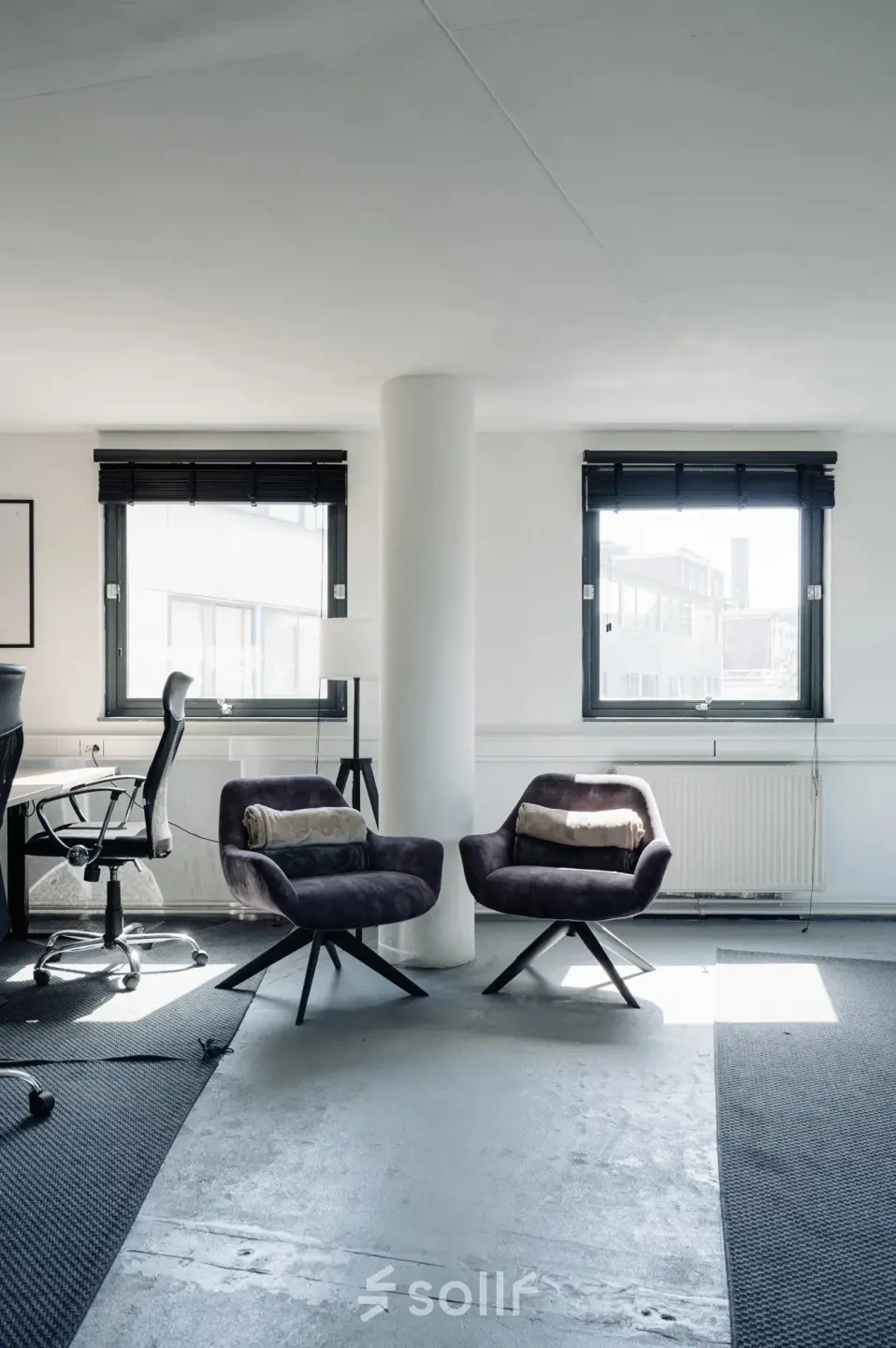 Bright office space with chairs and a desk in Amsterdam Canal Belt, ideal for rent office space enthusiasts.