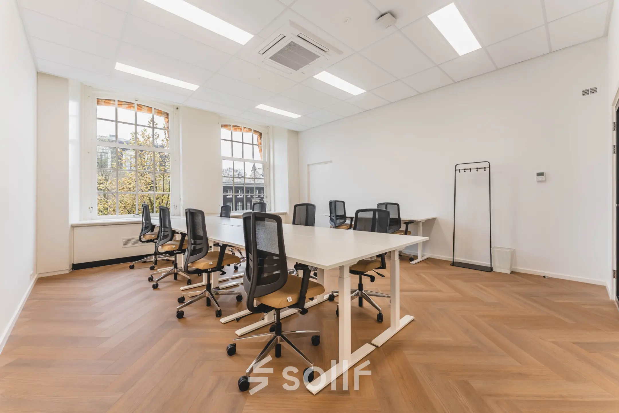 Bright and spacious office space rental at Herengracht 471, Amsterdam Center, featuring modern chairs and tables arranged for collaborative work.