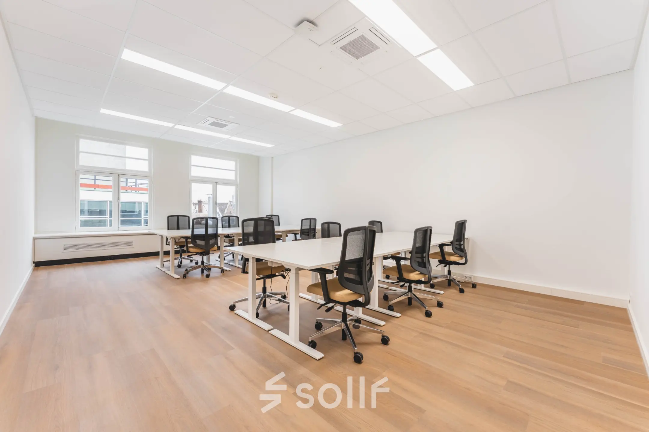 Bright office space with several desks and chairs arranged for workspace rental at Herengracht 471, Amsterdam Center.