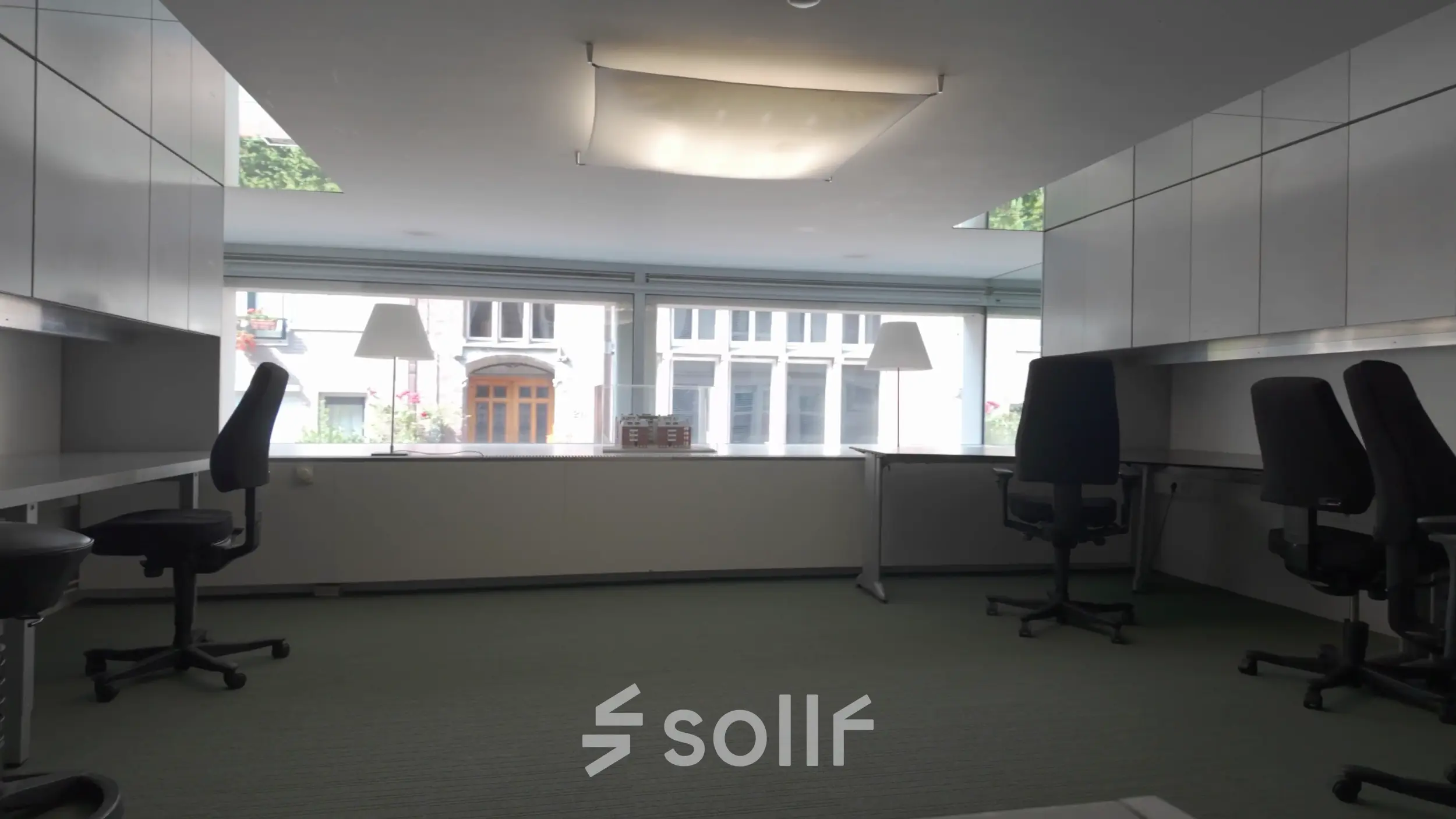 Bright office space at Kerkstraat 204, Amsterdam Center, ideal for rent with large windows and modern furnishings, offering a practical office space rental opportunity.